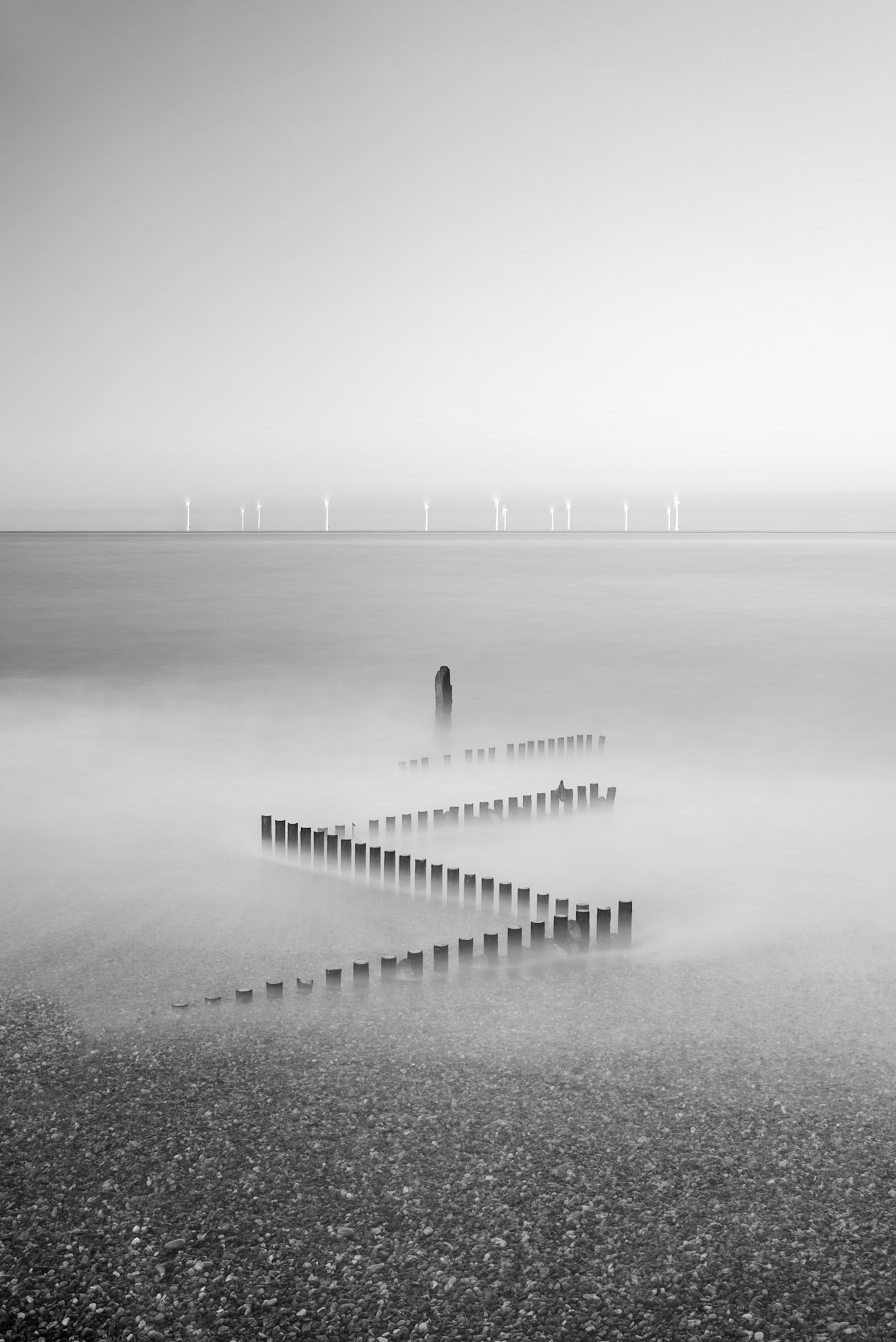 Groyne and wind farm long exposure along Norfolk coast. Costas Kariolis