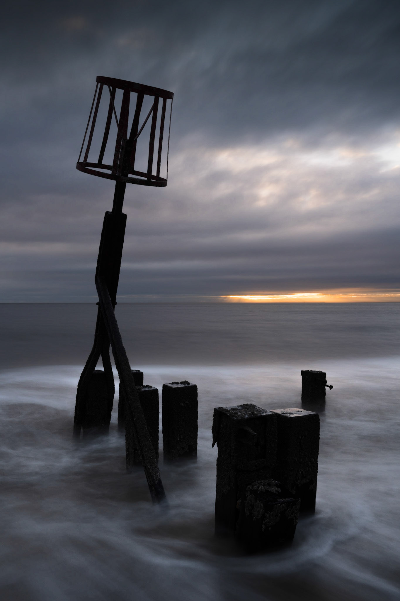 Sea defences during moody sunrise, Norfolk