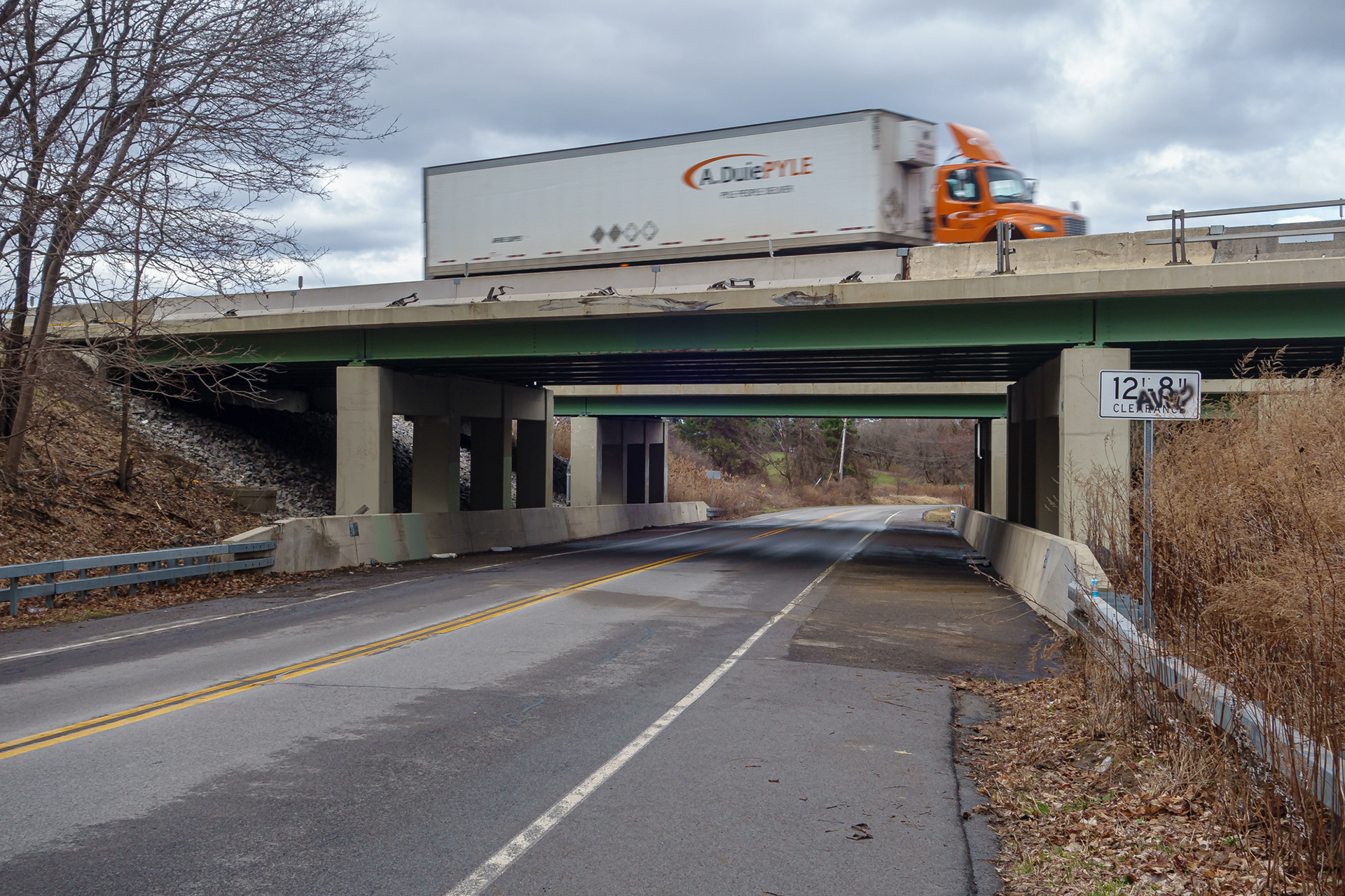 Damaged New York State Thruway Bridge over Mendon Center Road with Truck Passing