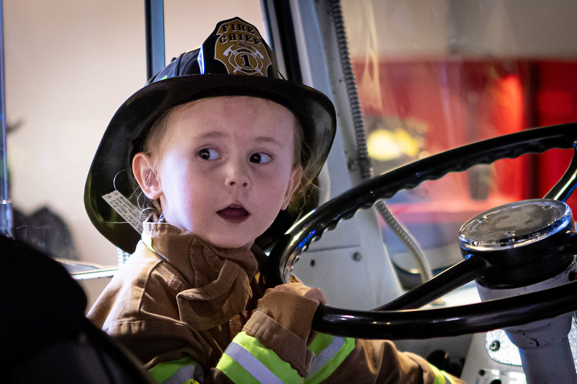 Taking a spin in the fire engine with Me-me at the Children's Museum