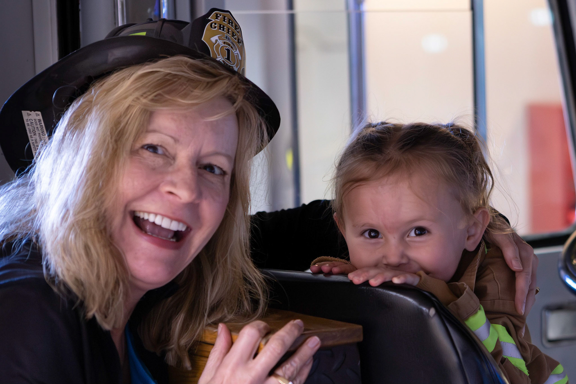 Taking a spin in the fire engine with Me-me at the Children's Museum
