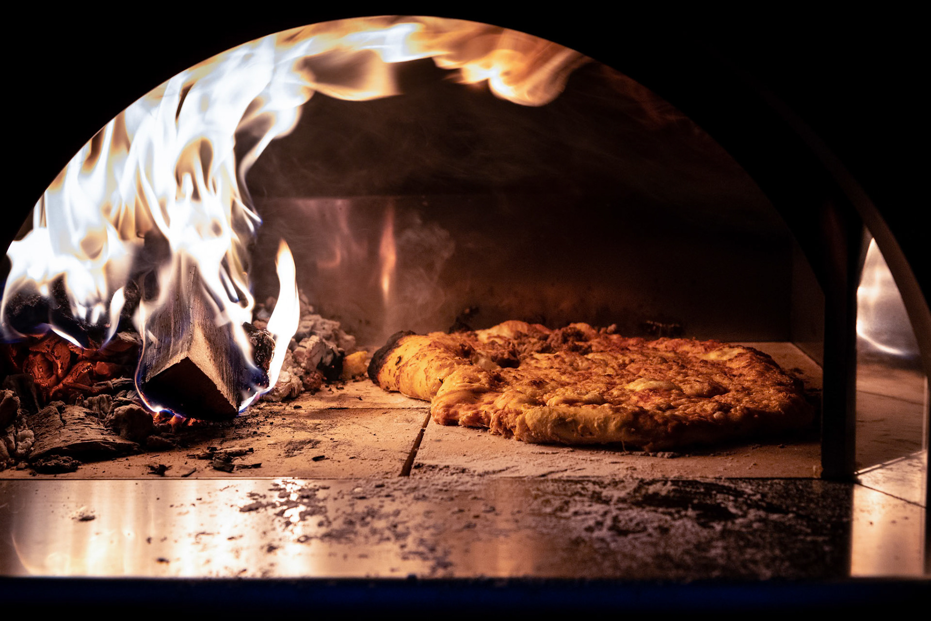Wood-fired pizza oven in action