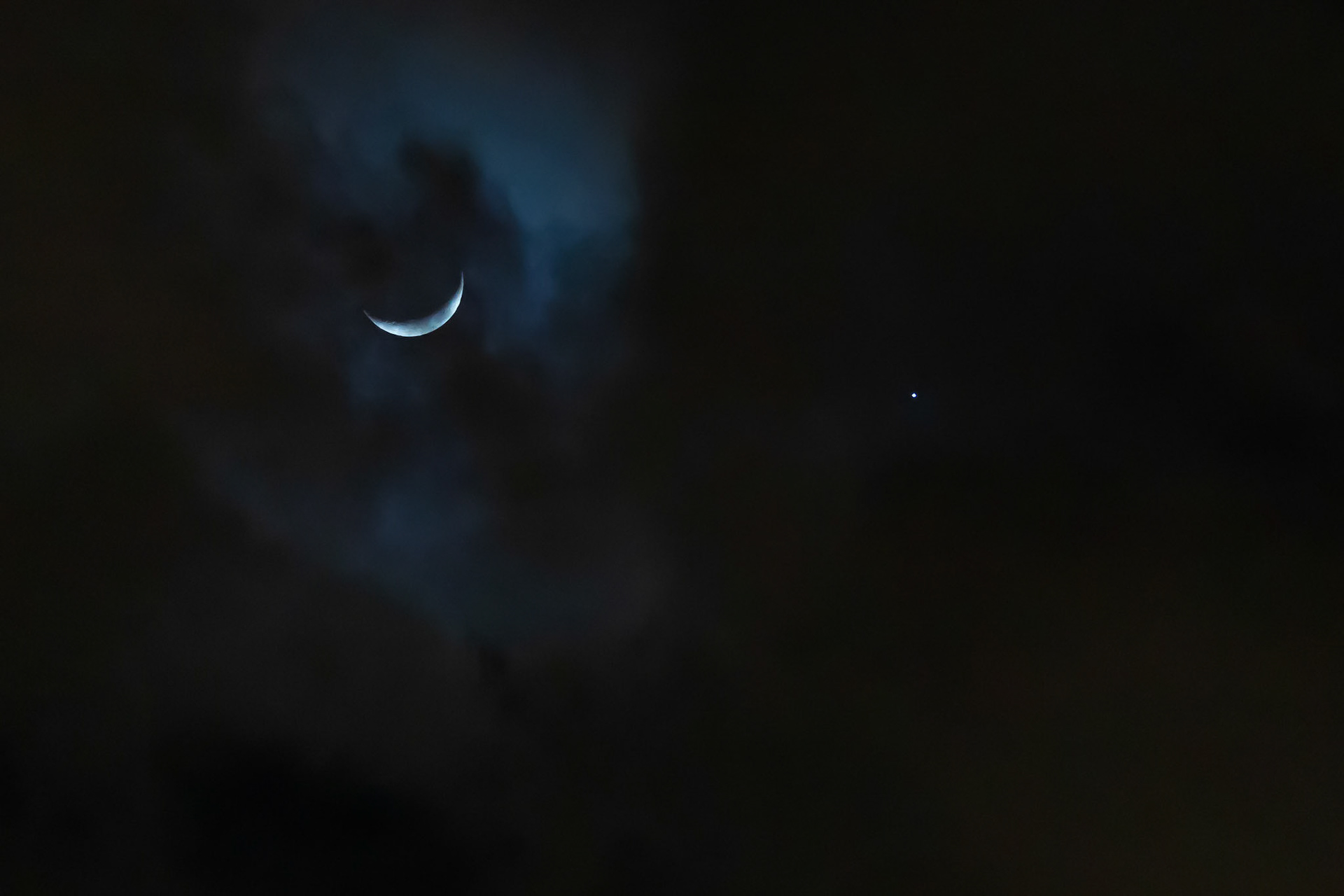 A crescent moon lingers near Venus
