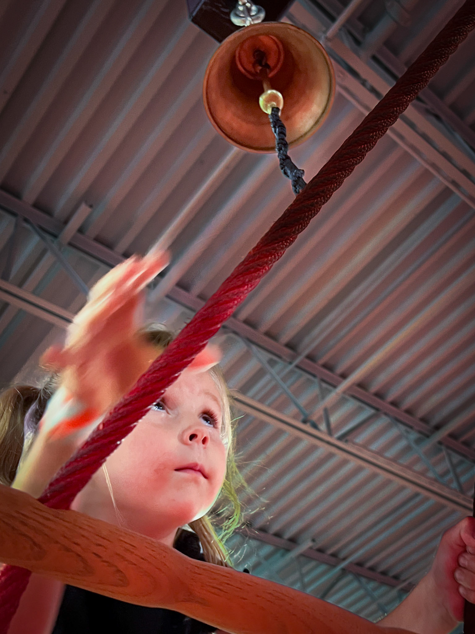 Ringing the bell atop a challenging rope ladder at Lava Island