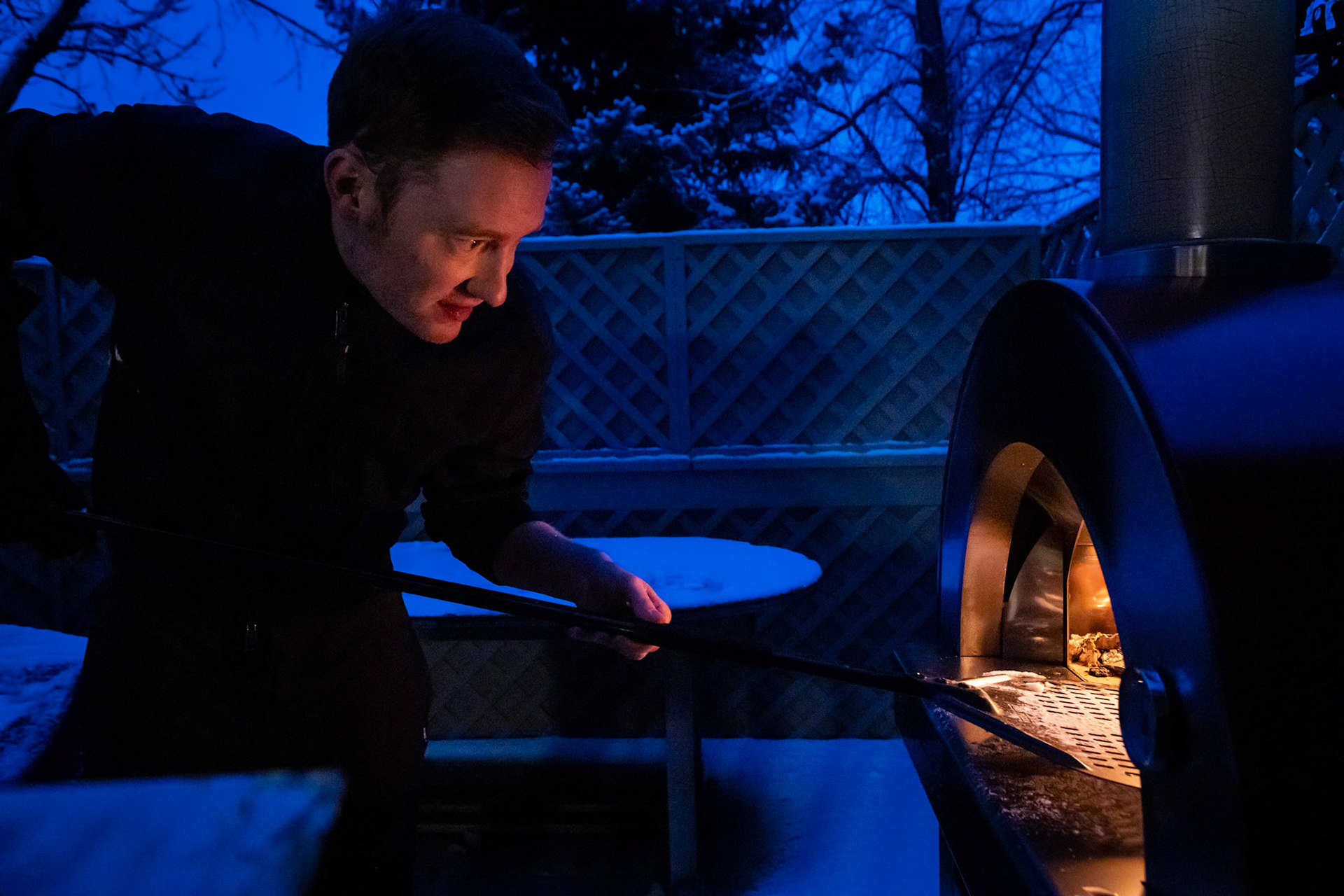 Firing up the wood-fired pizza oven for the first time