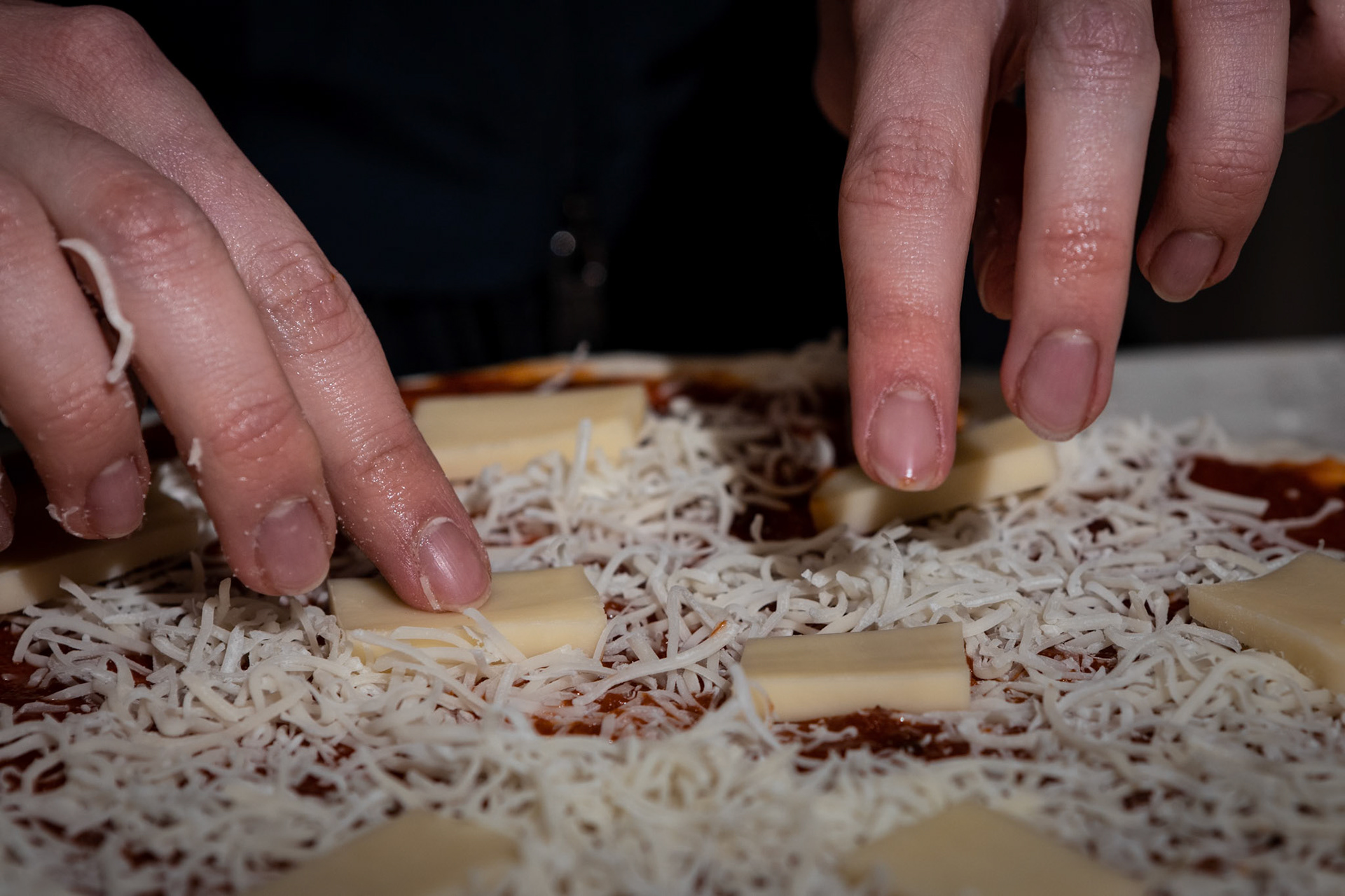 Whipping up a pie for the pizza oven