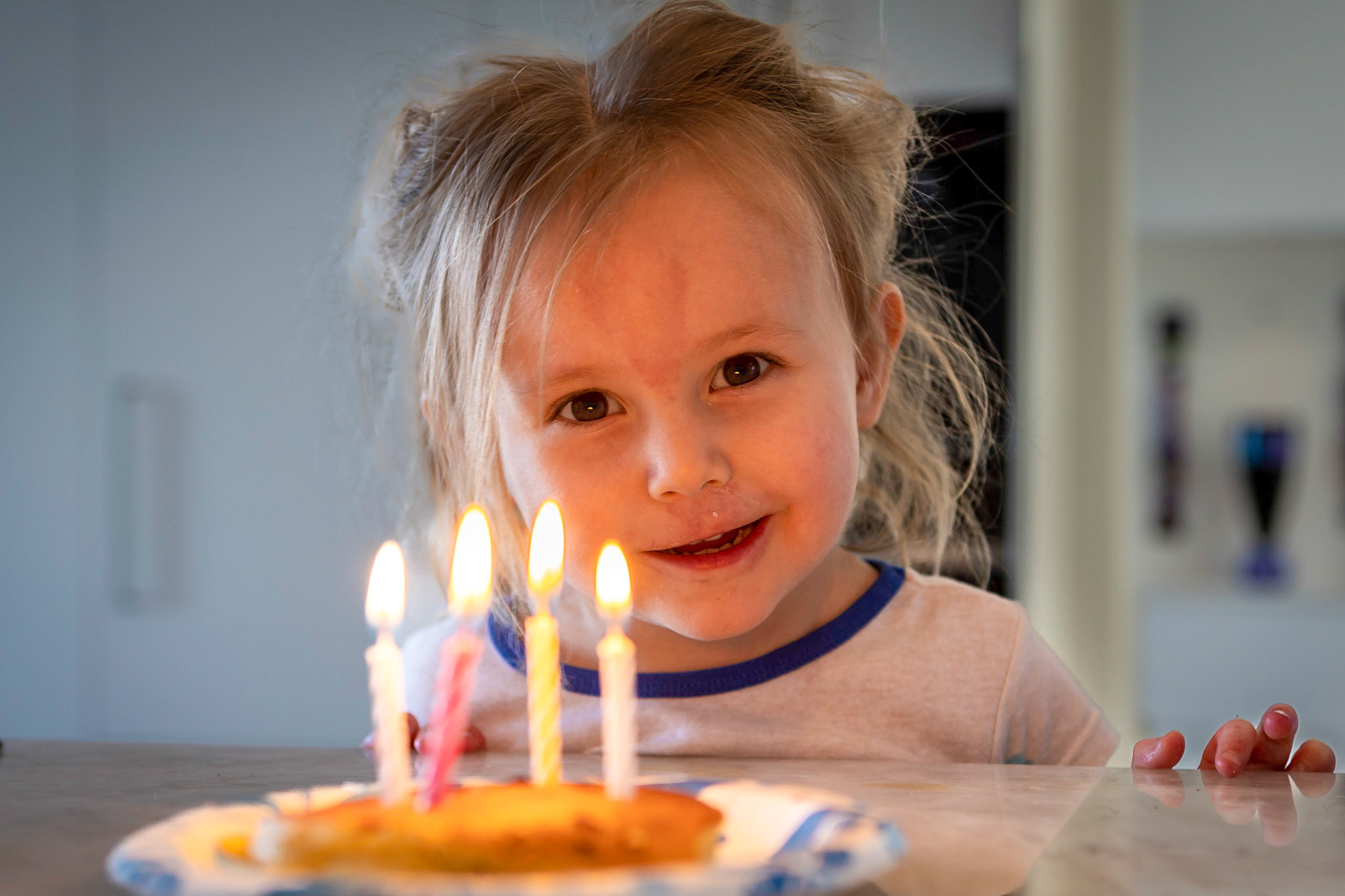 Practicing candle-blowing skills on a stack of pancakes