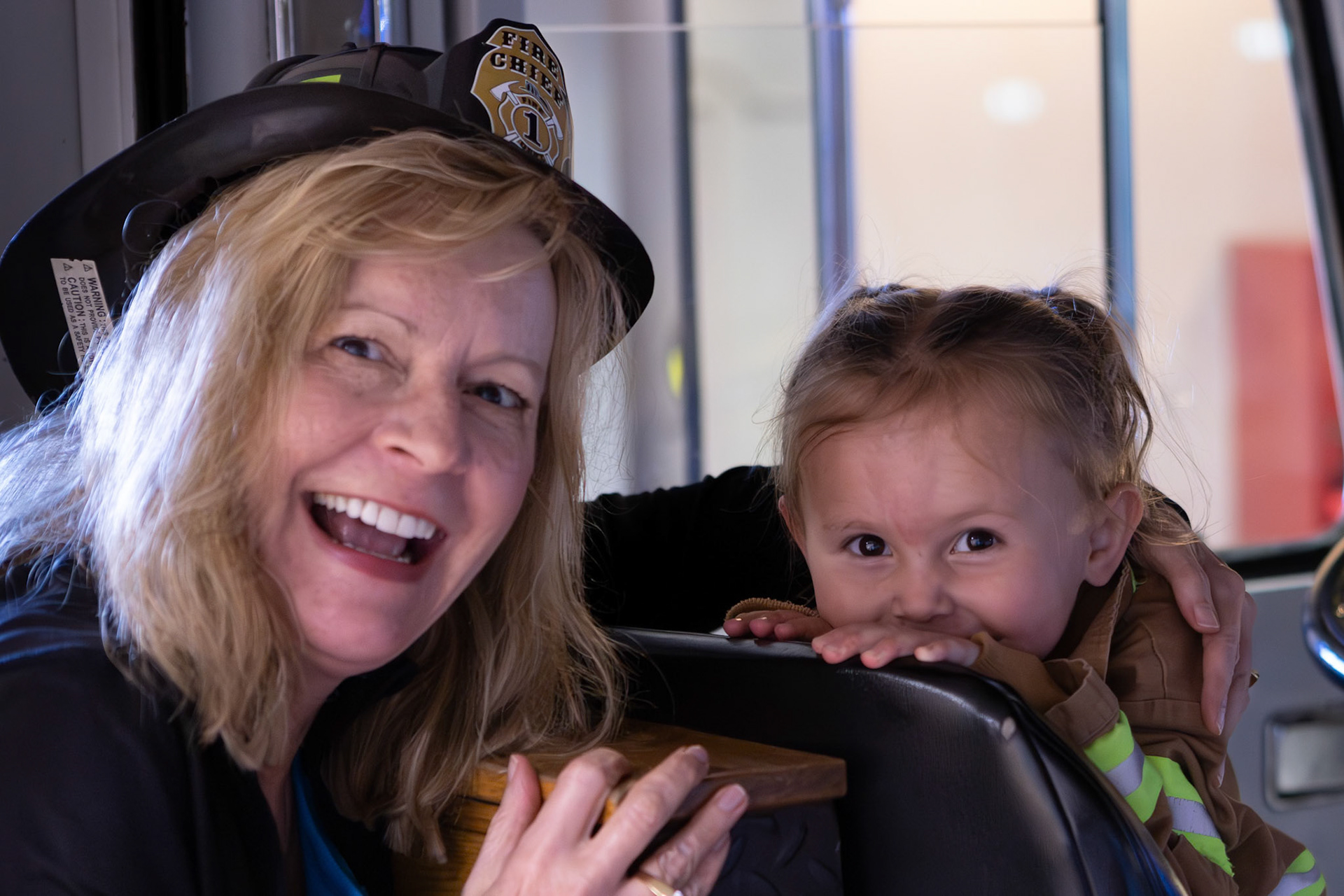 Taking a spin in the fire engine with Mimi at the Children's Museum