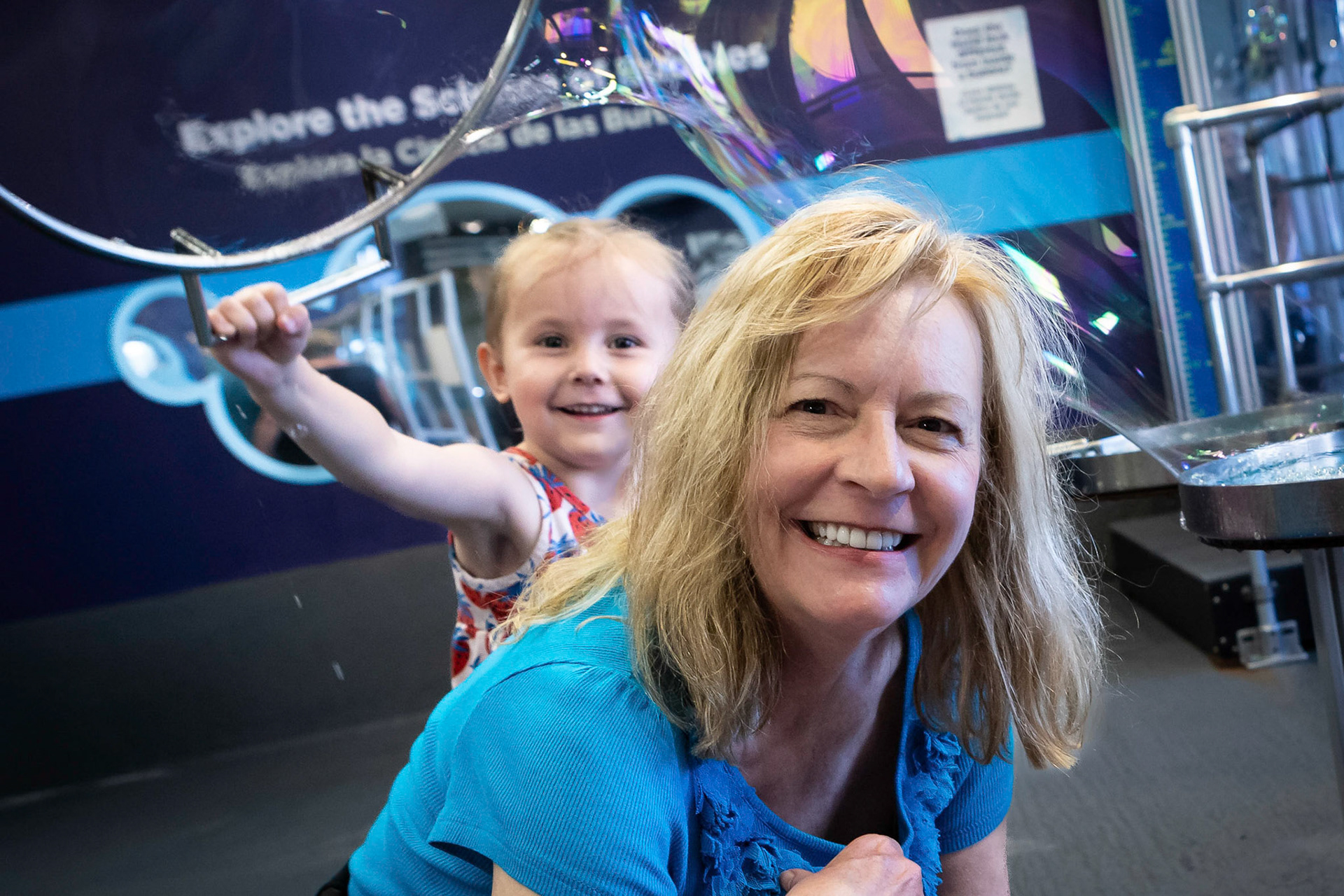 Covering Me-me with a big bubble at the Children's Museum