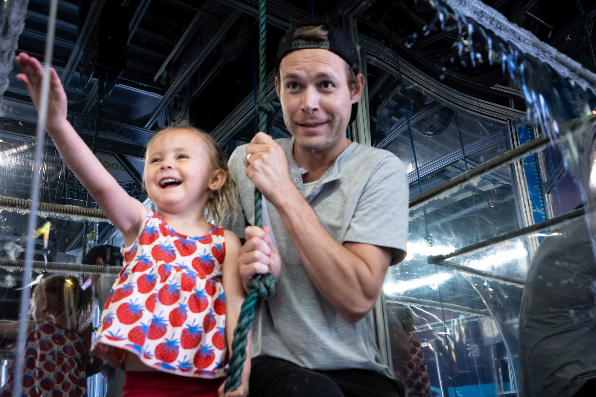 Raising a bubble curtain with Dad at the Children's Museum