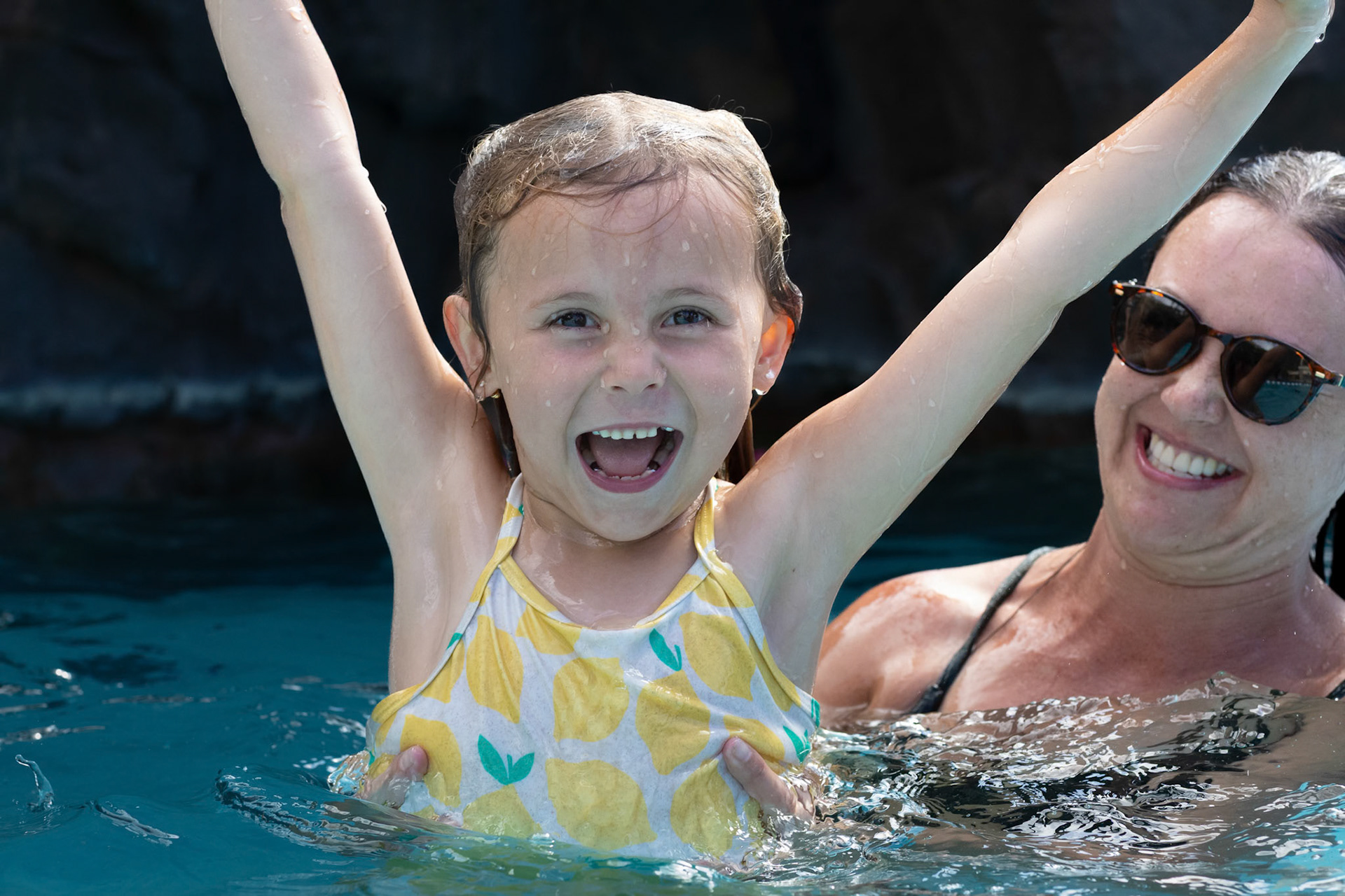Celebrating after a plunge down the aptly named Puka slide at Grand Wailea