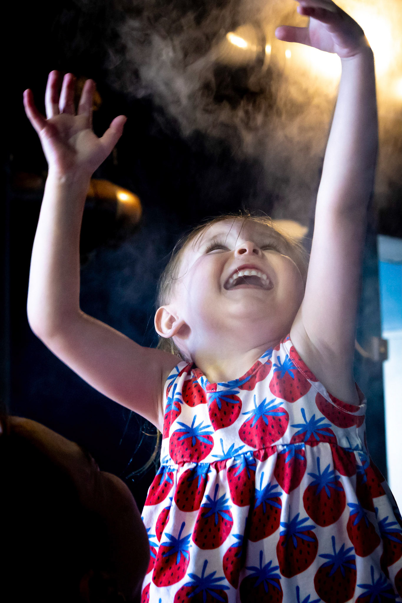 A pause under the mister on a warm day at the Children's Museum