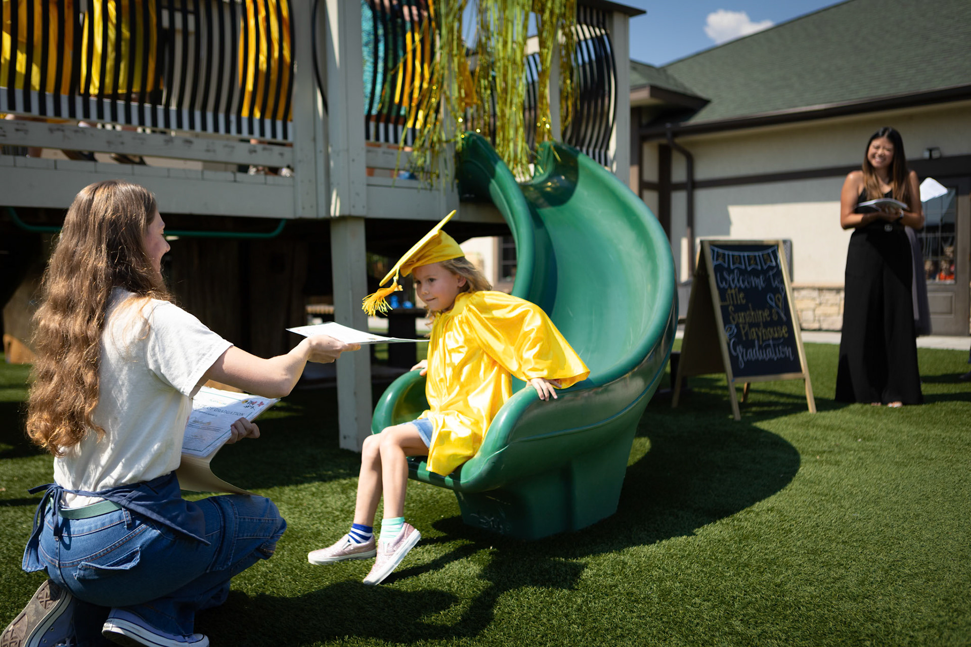 Heading down the slide to get her diploma