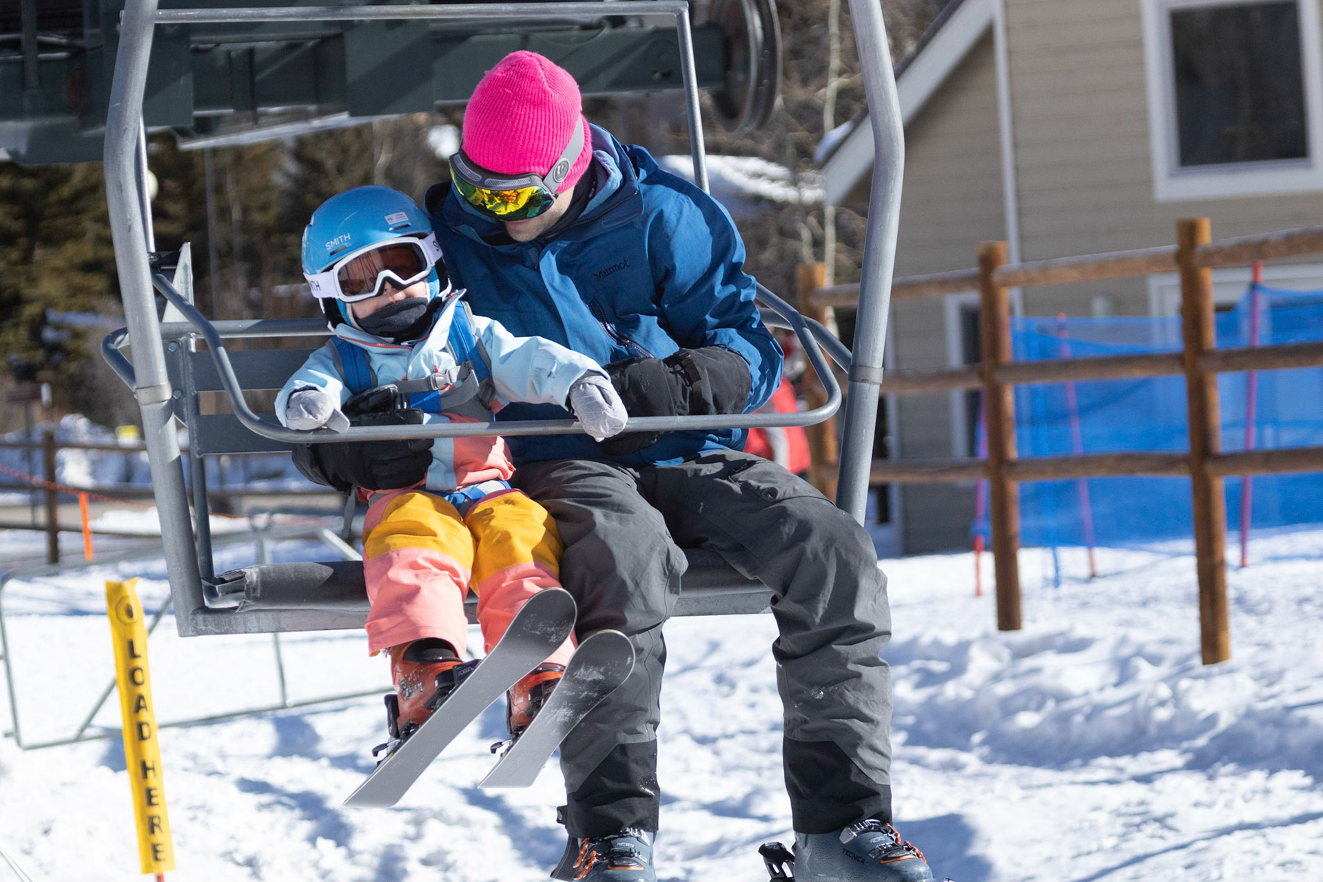 Safely aboard the ski lift with dad