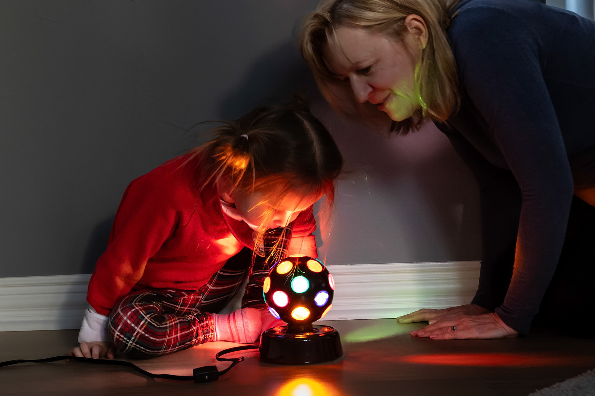 Examining the colorful lights of a disco ball