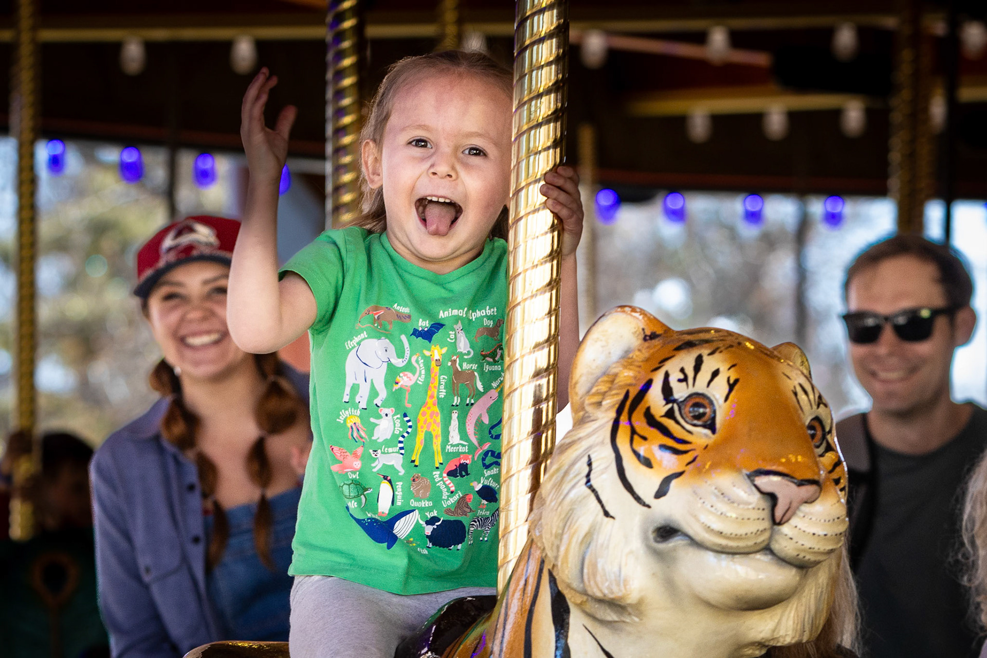 A spin on the carousel with Mom and Dad at the Denver Zoo