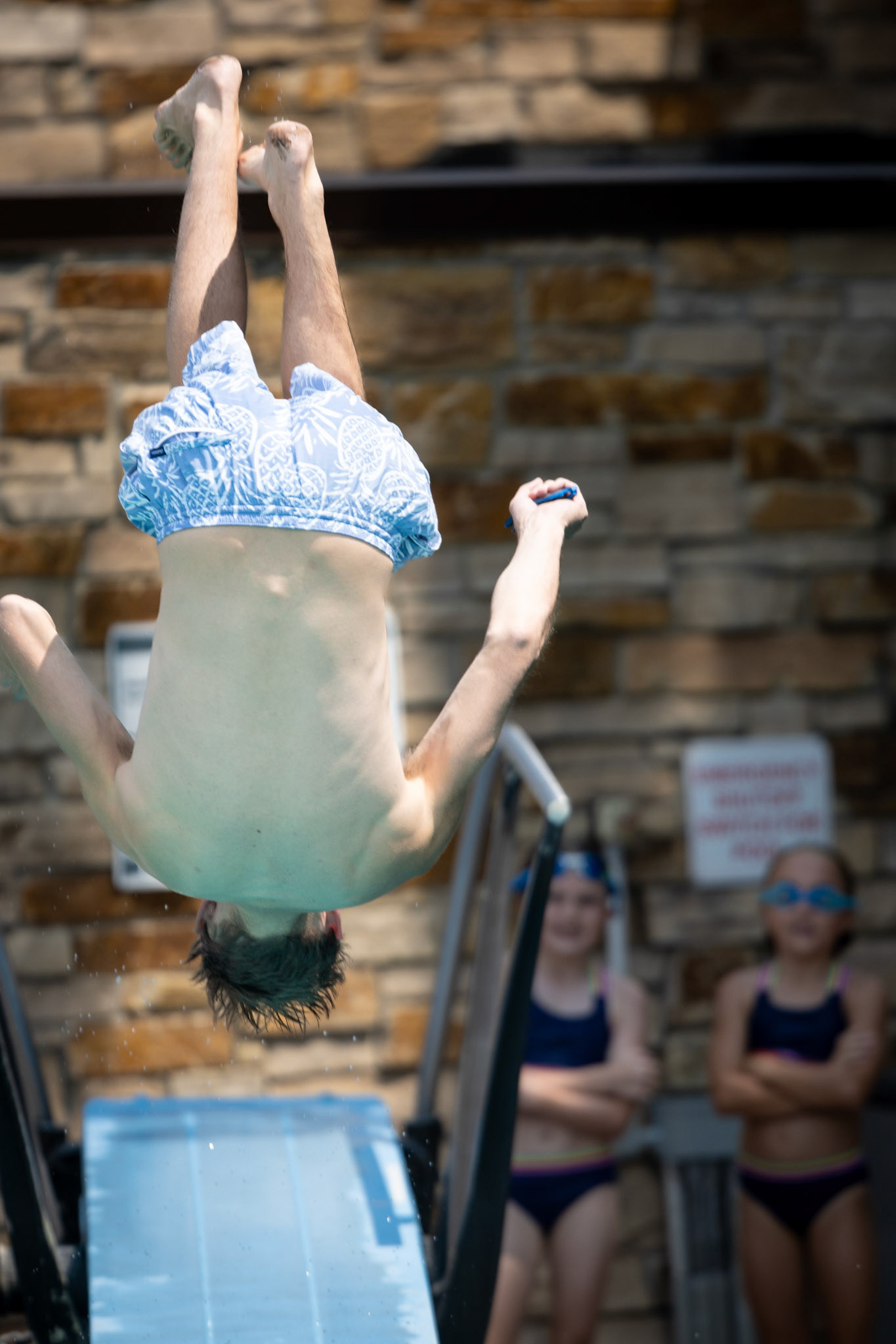 Dad practices his back flips off the diving board