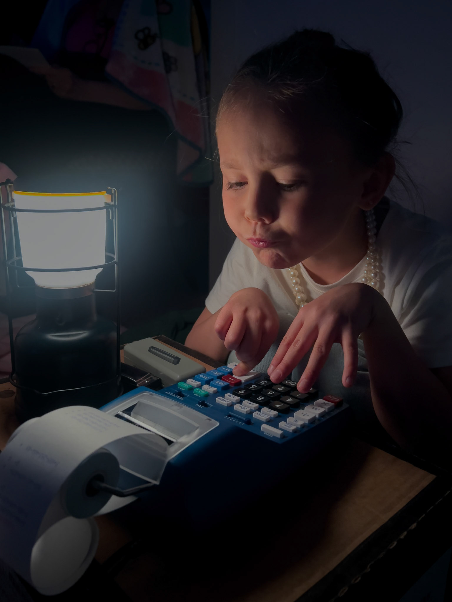 Playing tax accountant with her new adding machine