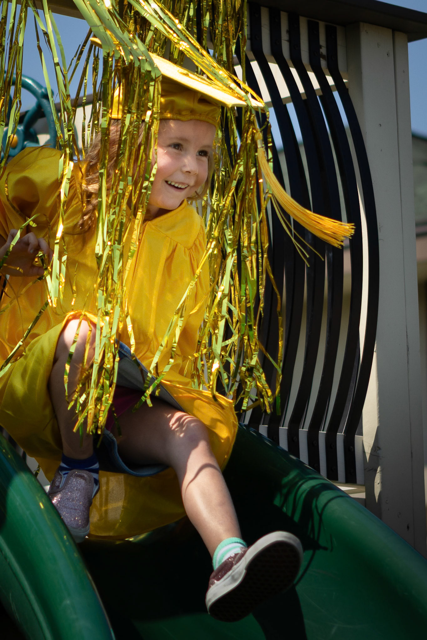 Heading down the slide to get her diploma