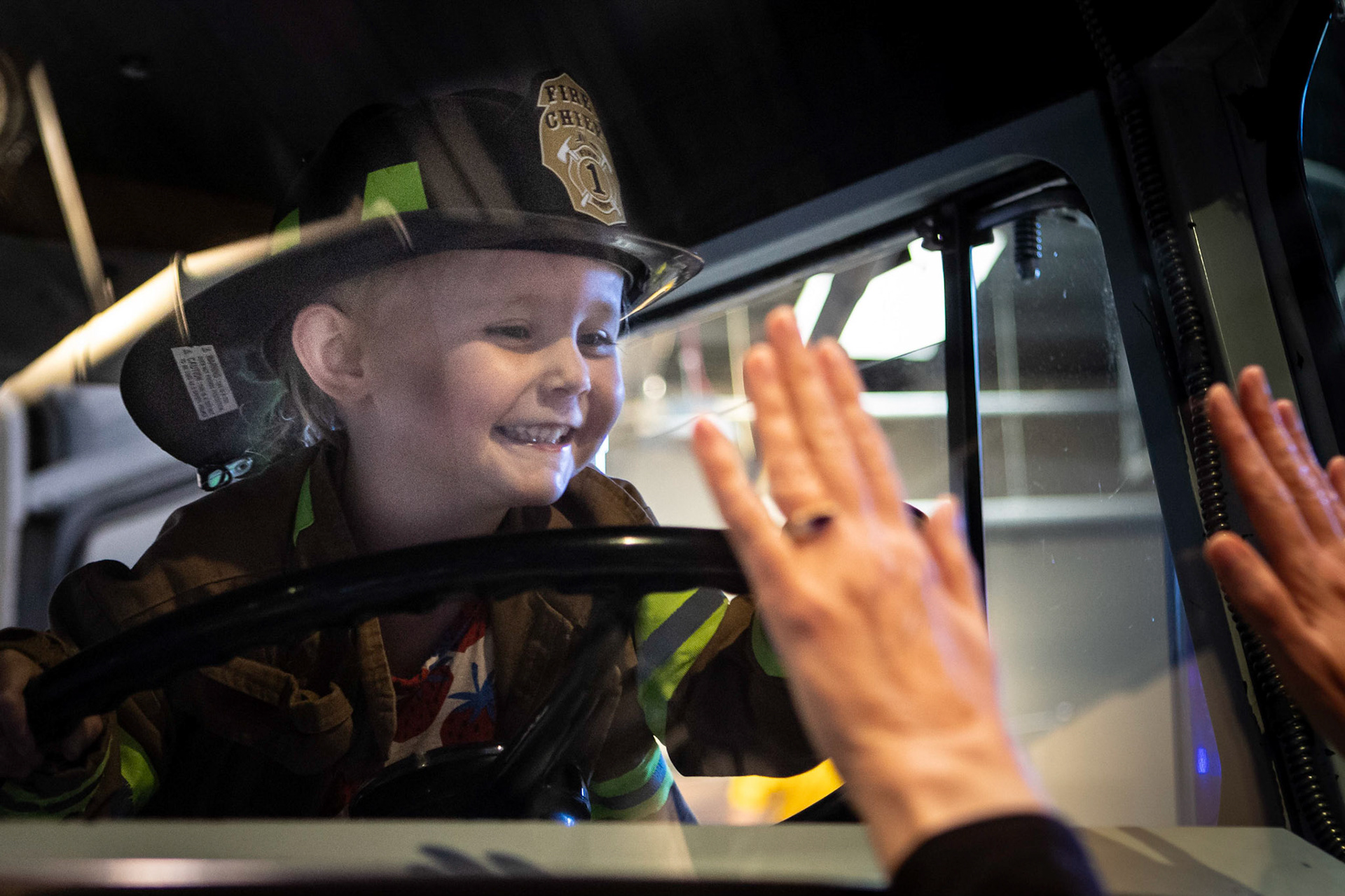 Taking a spin in the fire engine with Me-me at the Children's Museum