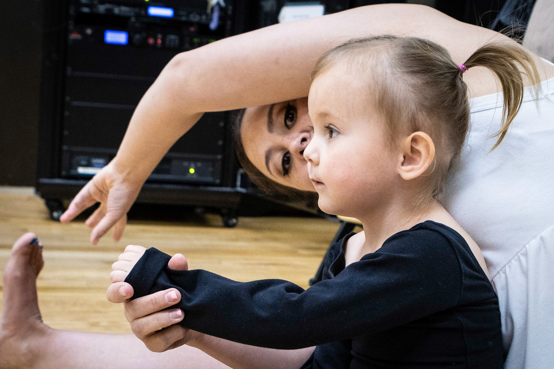 Learning to stretch with mom in ballet class