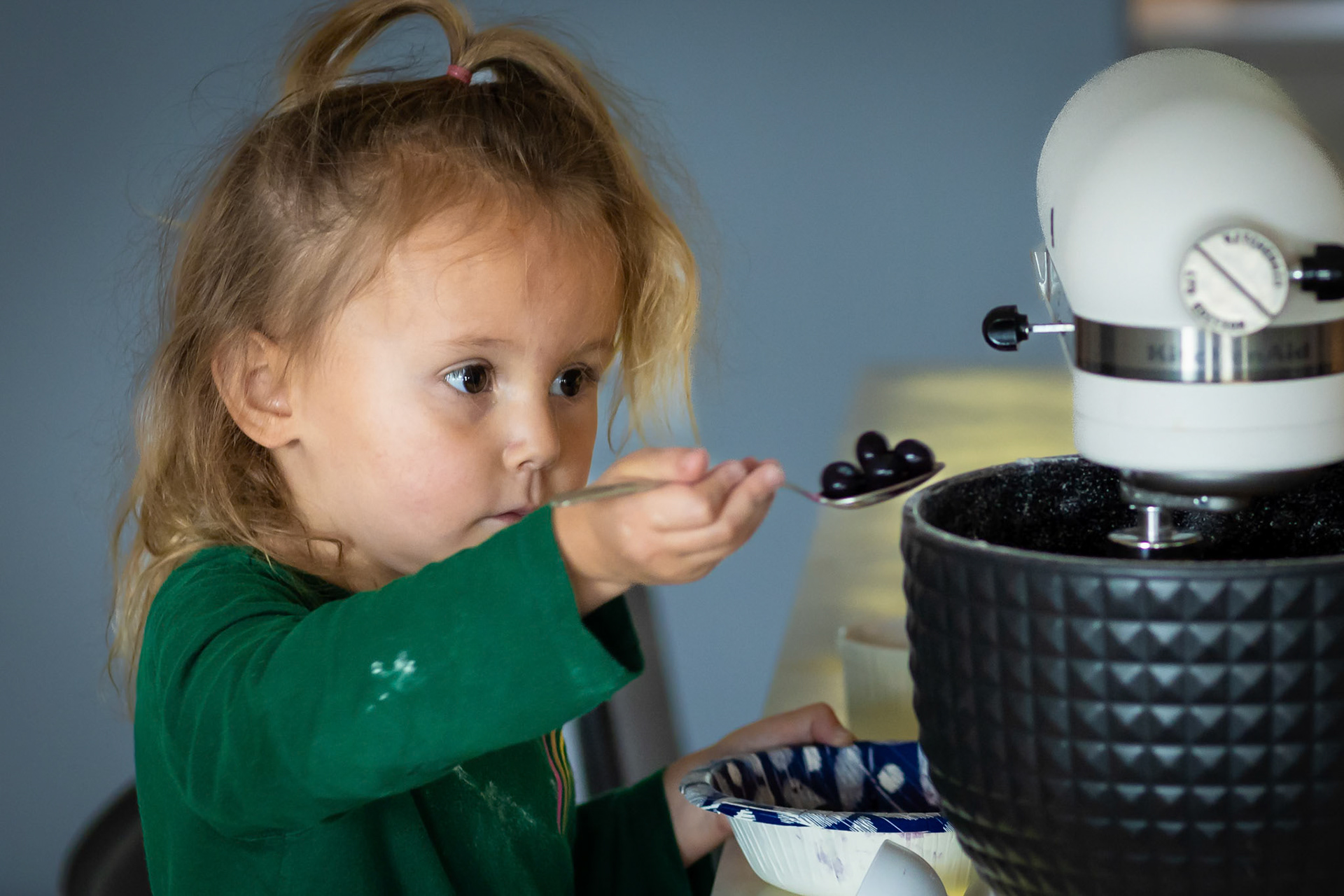 Carefully measuring the ingredients for blueberry pancakes