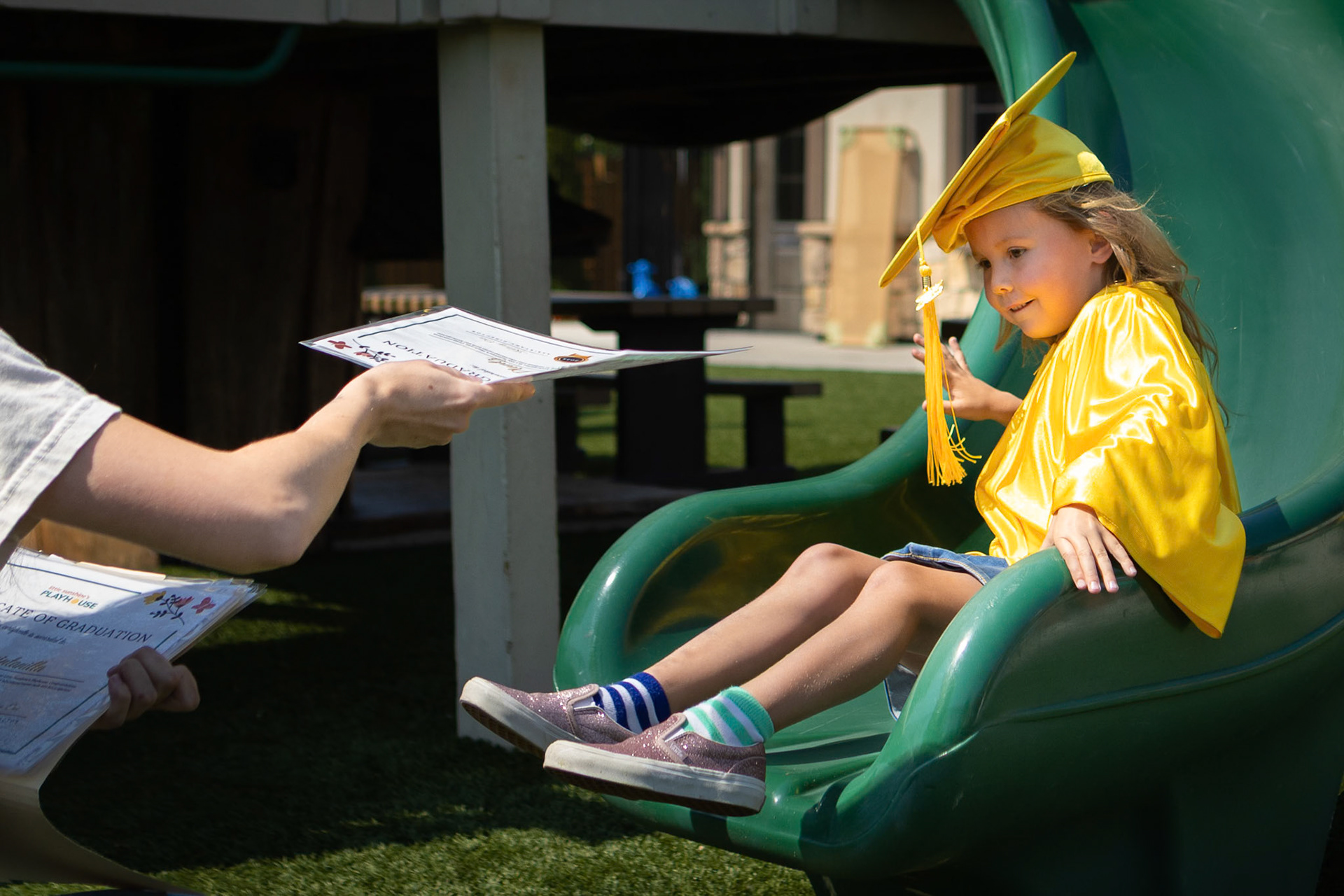Heading down the slide to get her diploma