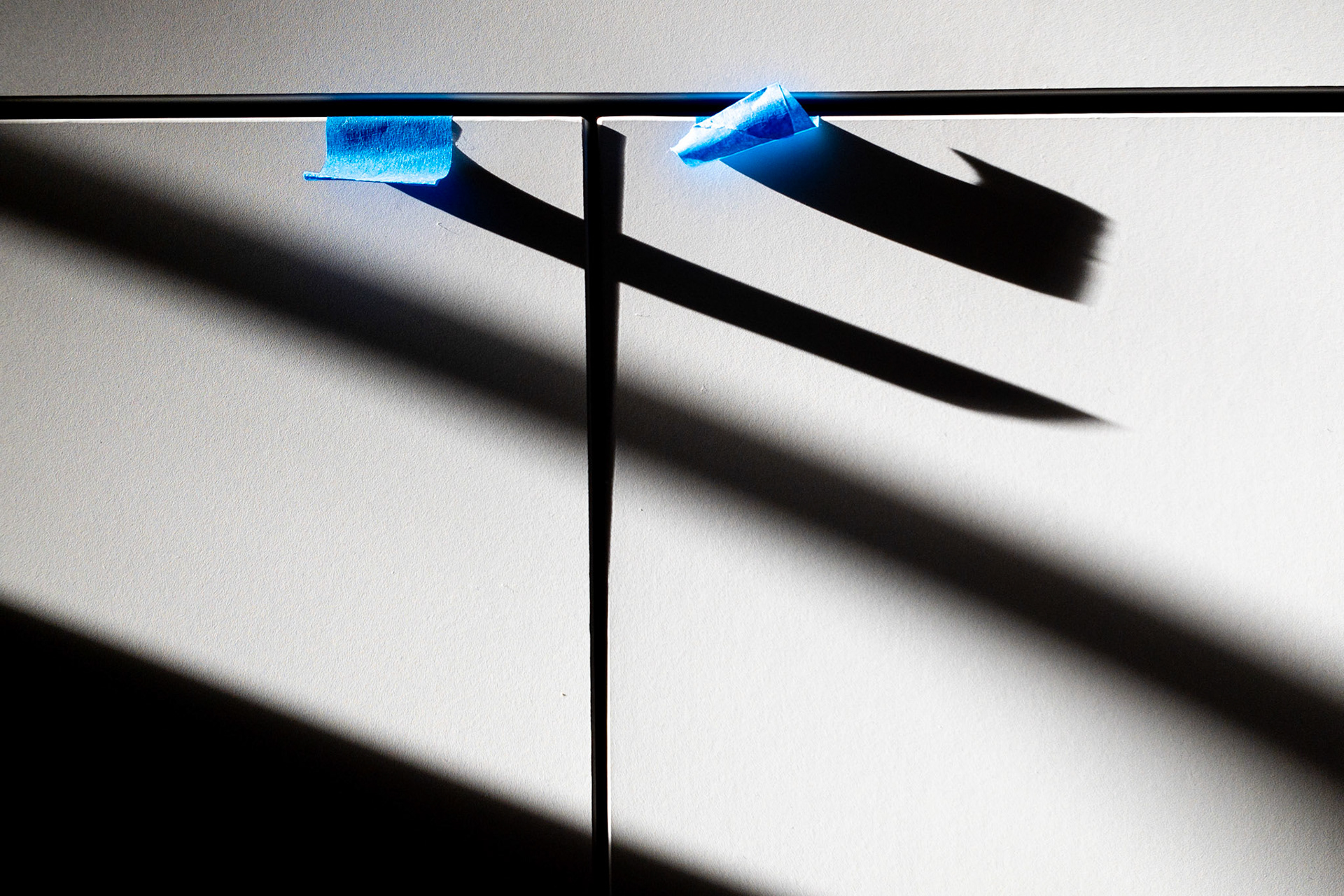 Blue tape replaces door handles as a kitchen remodel winds down