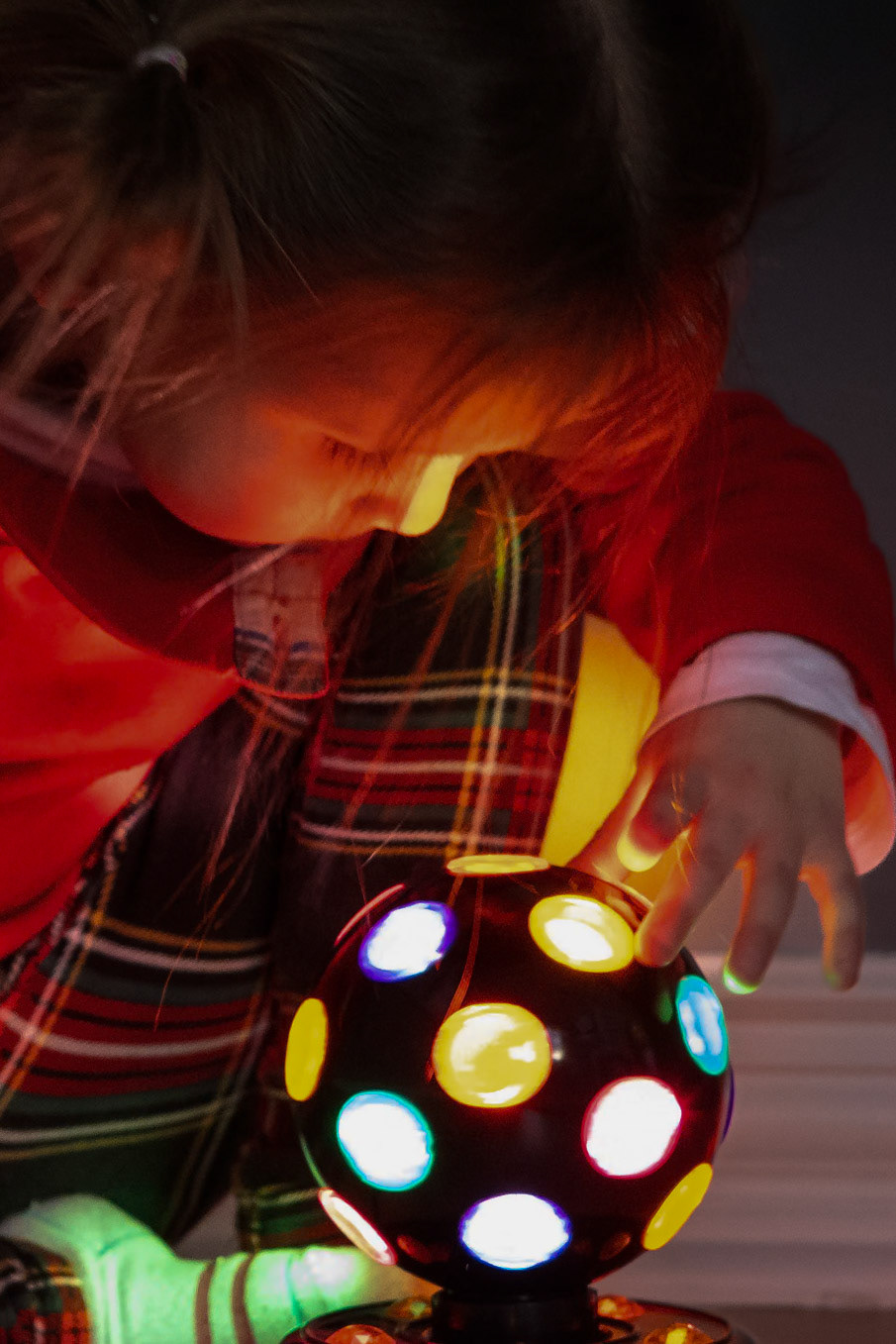 Examining the colorful lights of a disco ball