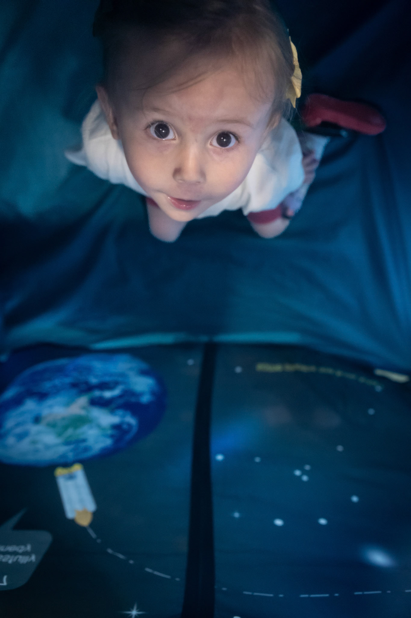 Playing in the space tent at Koelbel Library