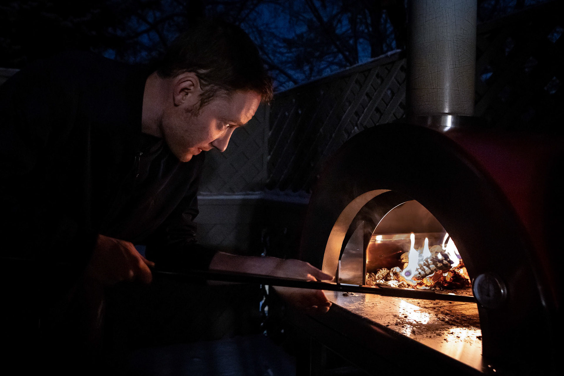 Firing up the wood-fired pizza oven for the first time