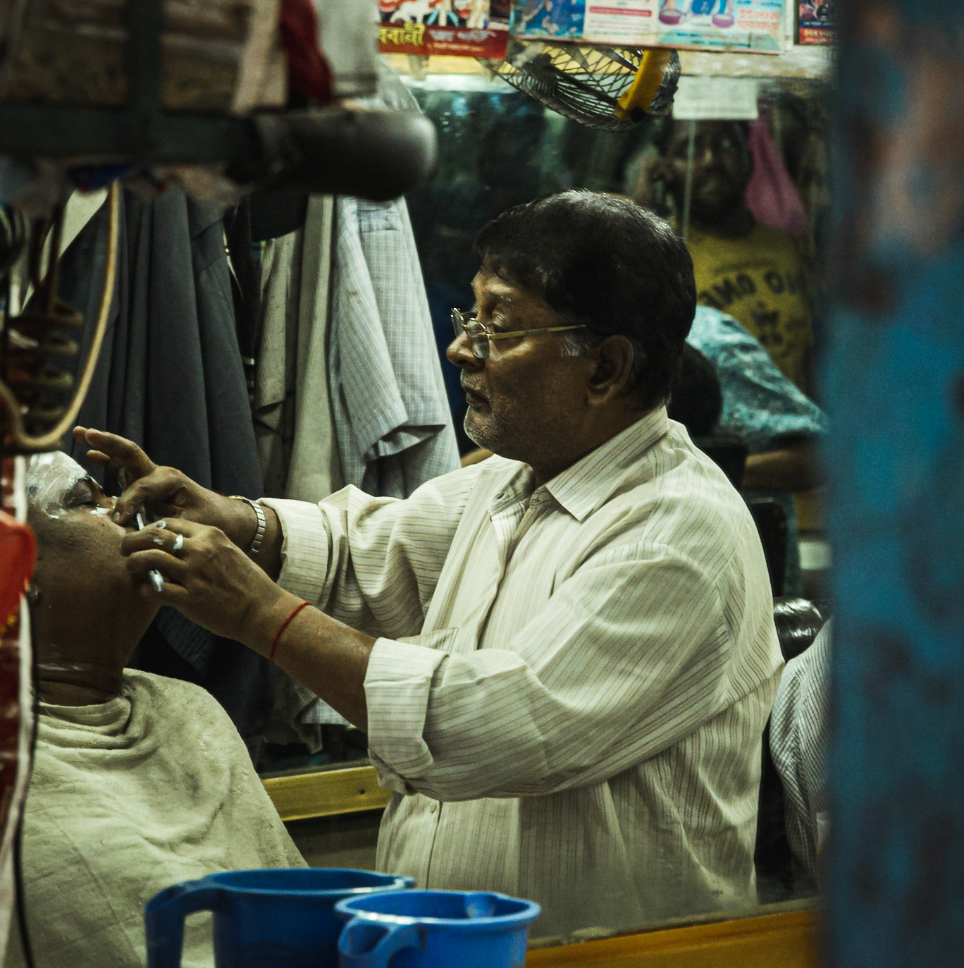 Mirror reflection of a barber shop on Hindu Street in Old Dhaka, Bangladesh