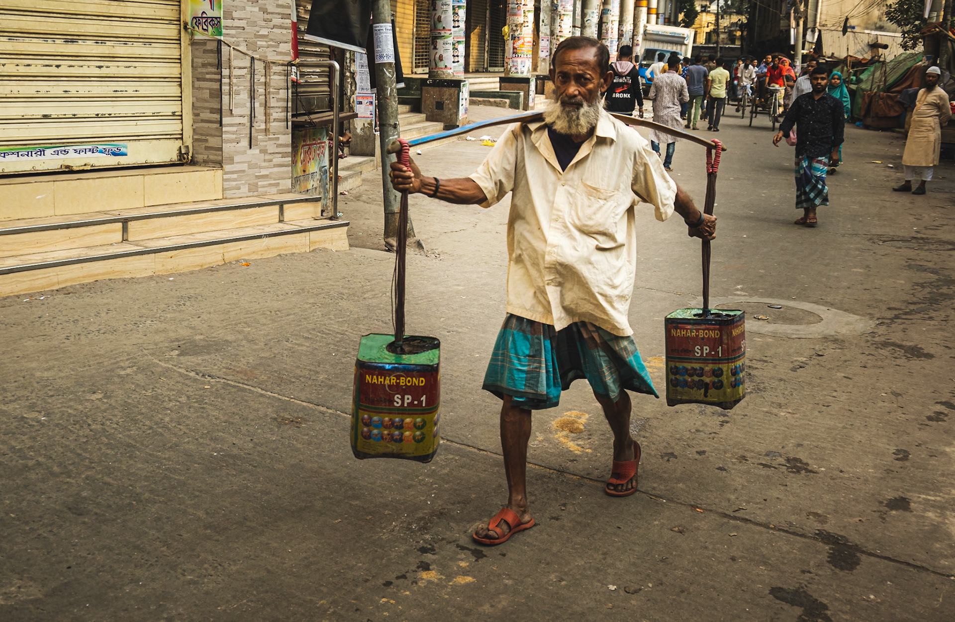 A man with a custom carrying contraption on the streets of Old Dhaka, Bangladesh.