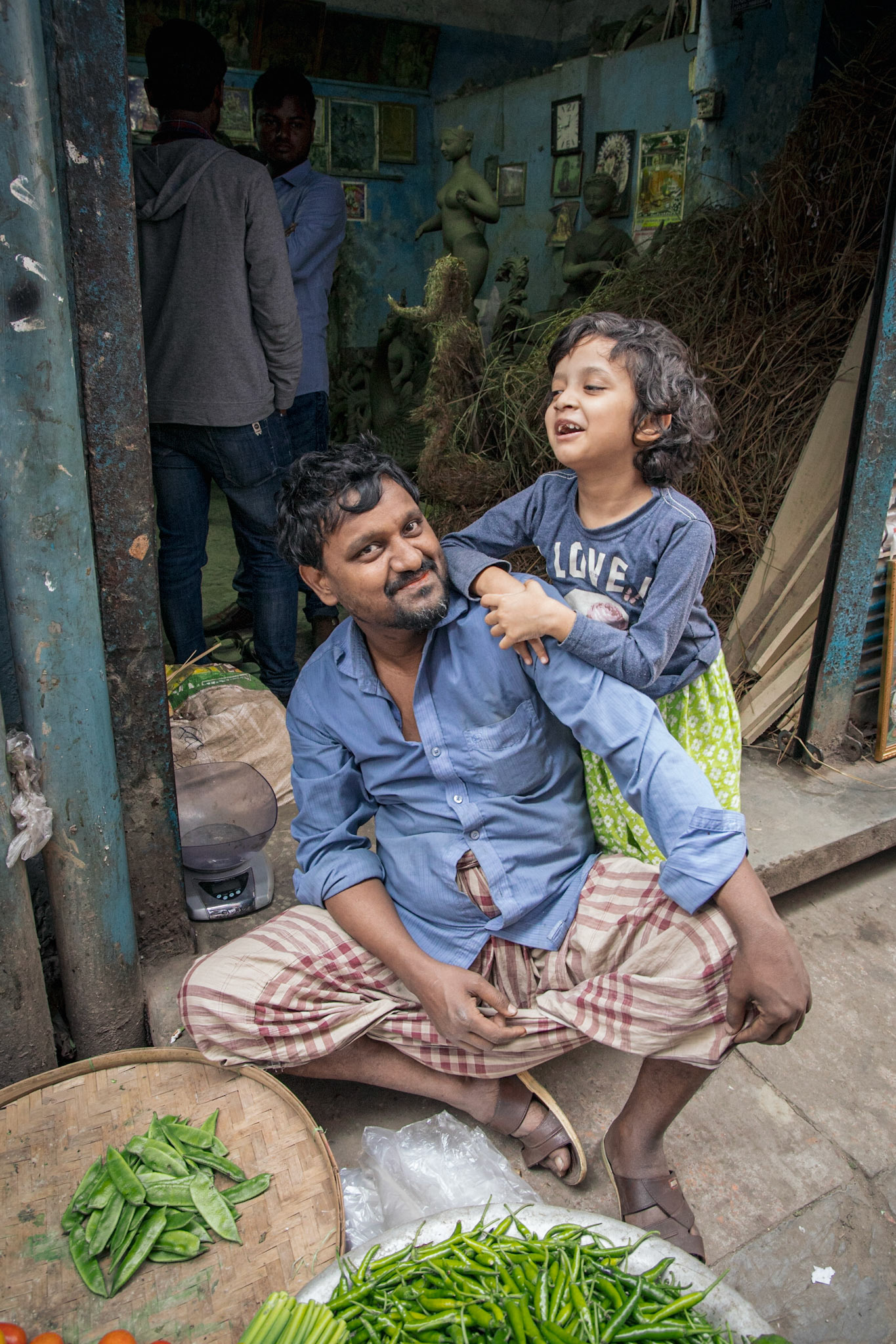 A man and his child selling peas on Hindu Street in Old Dhaka, Bangladesh.