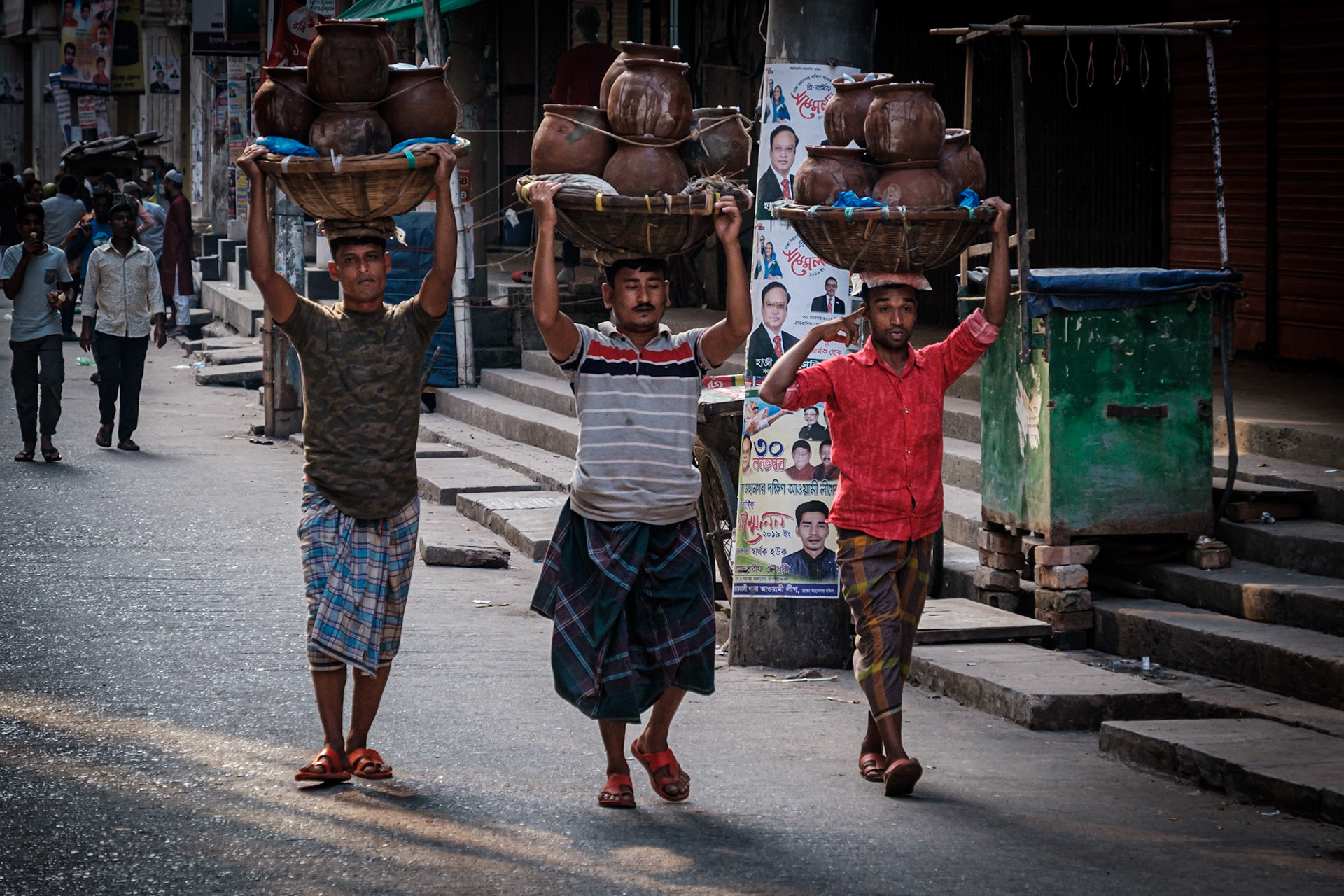 Three guys hauling their wares in Old Dhaka, Bangladesh.