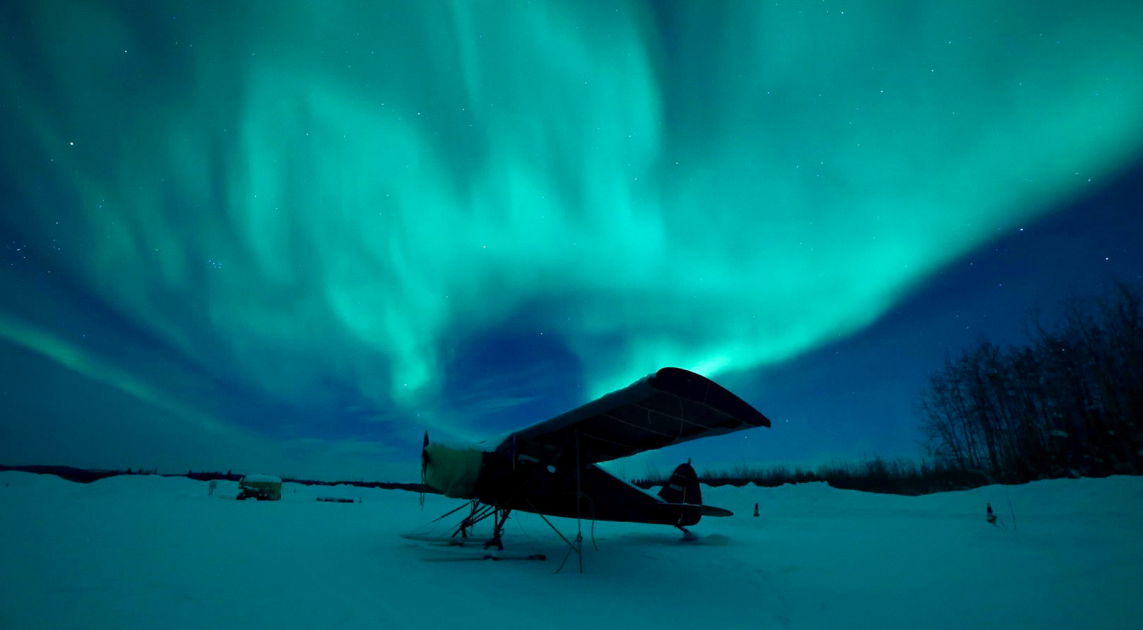 Aurora over a small plane at Bettles, AK