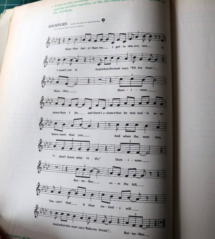 "Close-up photo of the sheet music and lyrics for 'Shoeflies' by Bob Sakayama in a vintage Silver Burdett education textbook."