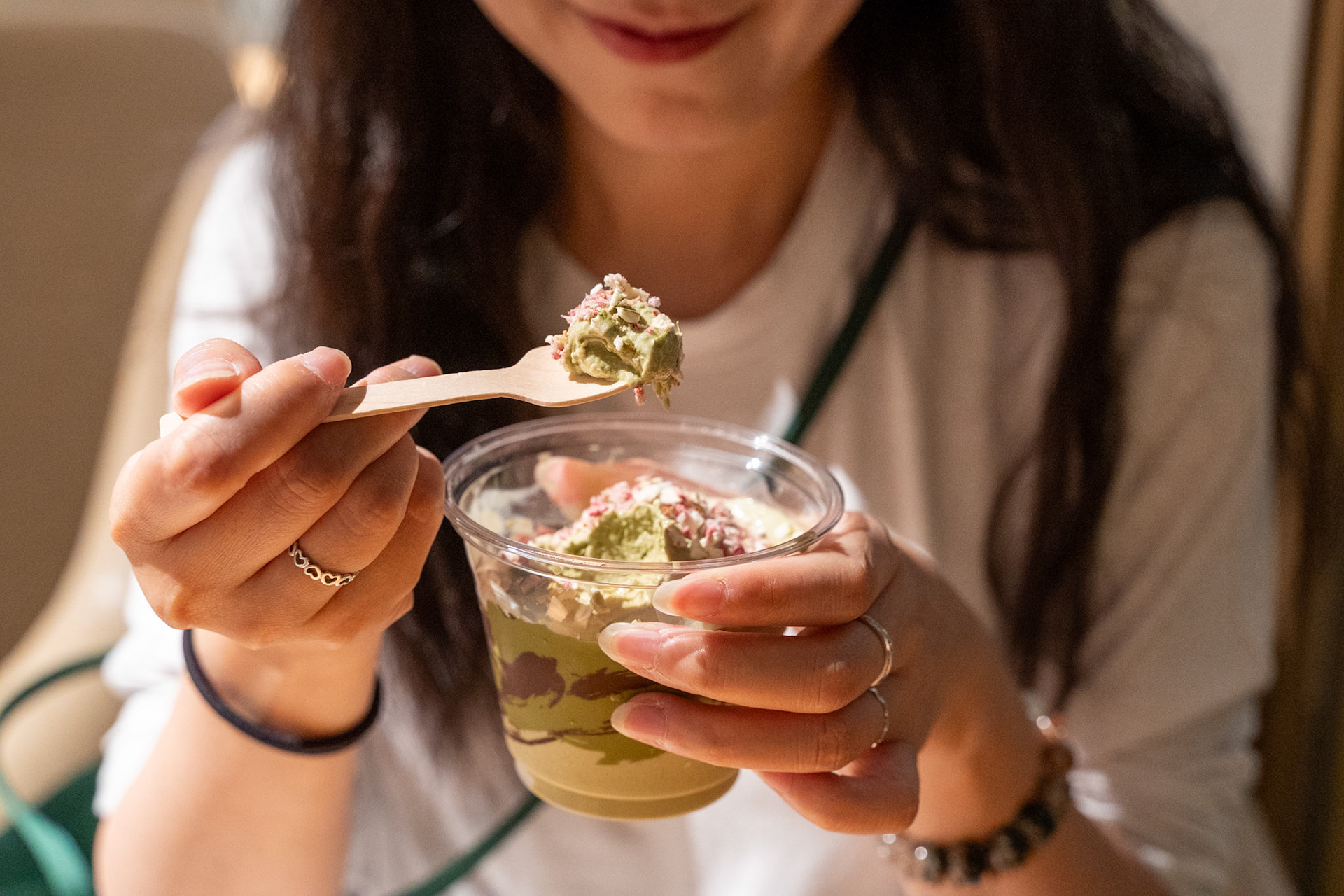 Woman enjoying matcha dessert in cozy setting