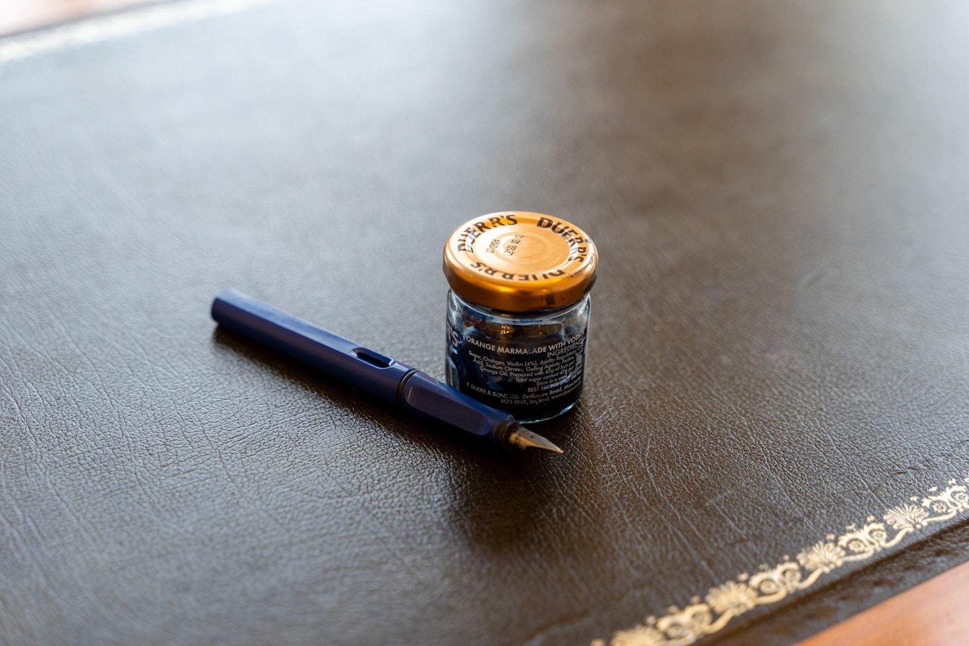 Fountain Pen and Ink Jar on Leather Desk