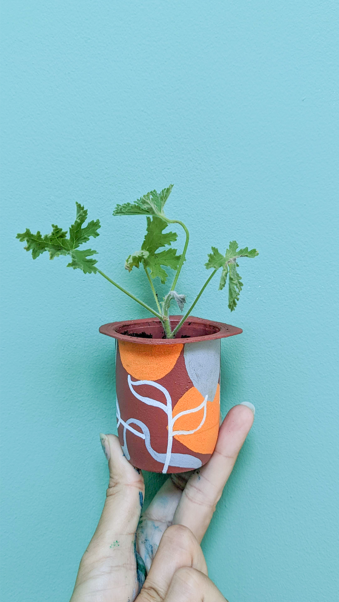 Activia yogurt pot • Citronella • “A yogurt pot seemed like a perfect container to plant something in, but I really didn’t like the look of it. So I painted a colorful pattern on it and drew leaves with markers. I like it much more now!”