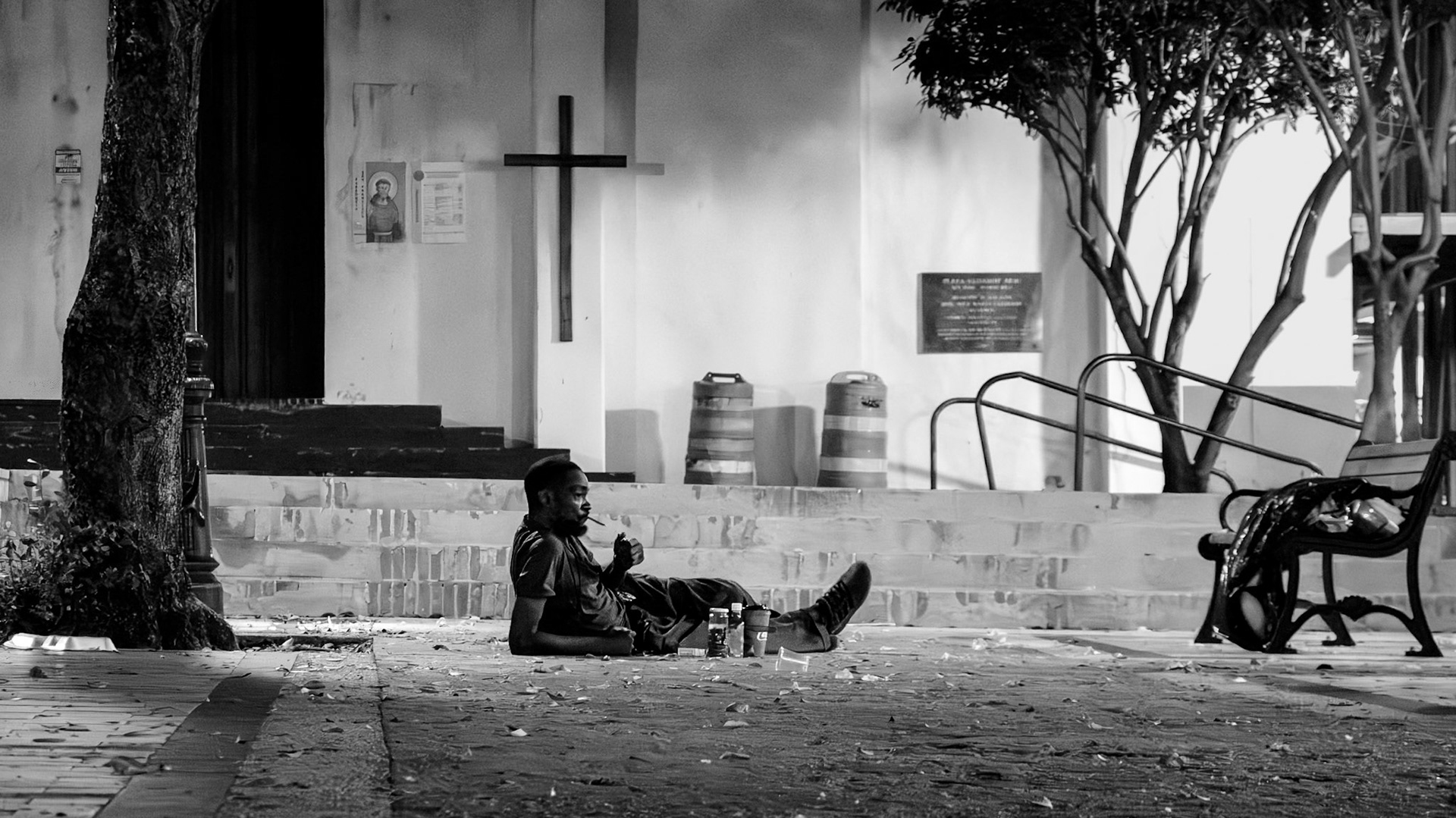 Homeless person relaxing in front of a church