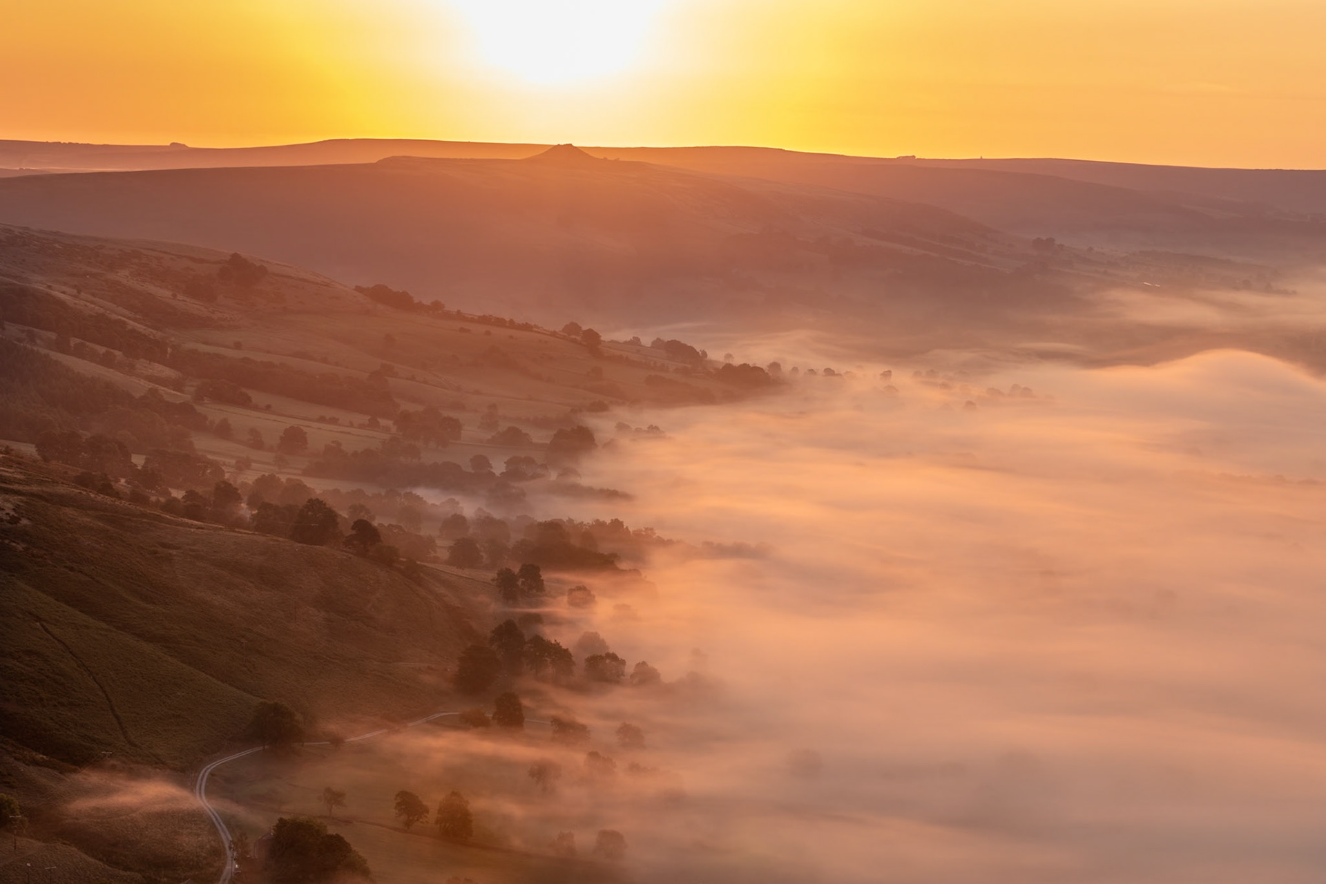 A spectacular scene unfolded as the sun rose over Hope Valley. When the sky turned golden the amazing light hit the cloud inversion below turning the mist into a sea of silky gold…