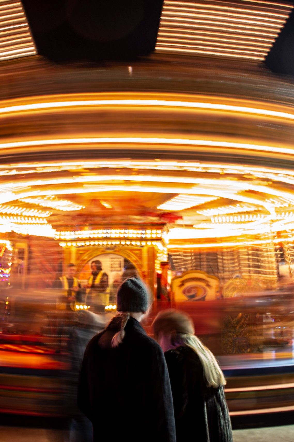 A quick snap of a couple sharing a moment in front of a Carousel at a Christmas Market, perfect opportunity to do a little long exposure, not helped by the freezing cold &amp; drizzle/rain but I'm fairly happy with the result.