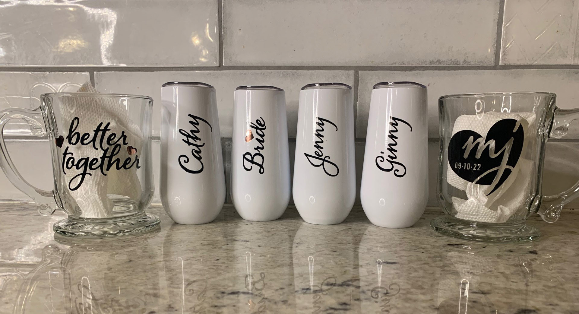 Wedding mugs and wine glasses on the counter