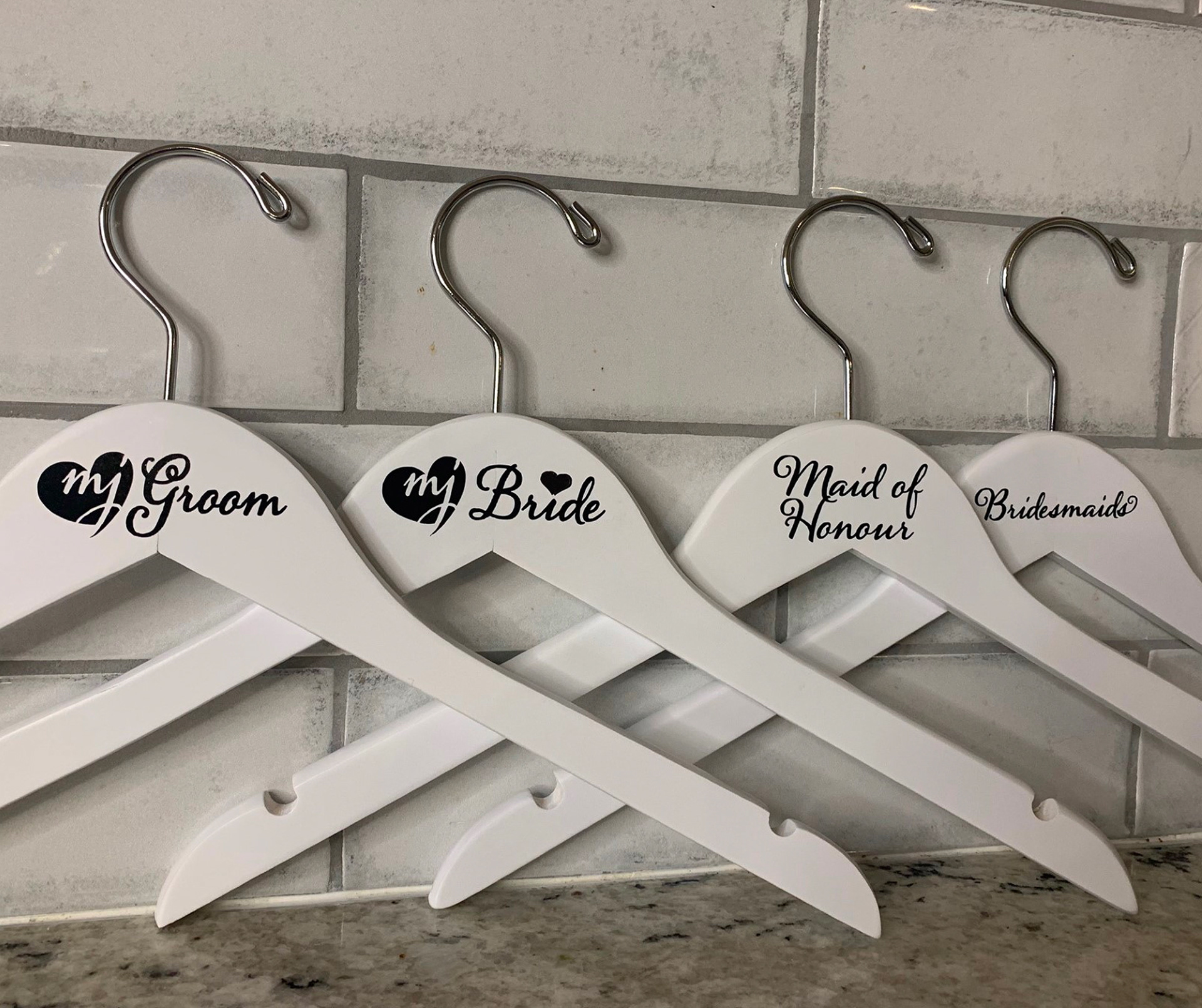 4 wedding coat hangers on the counter
