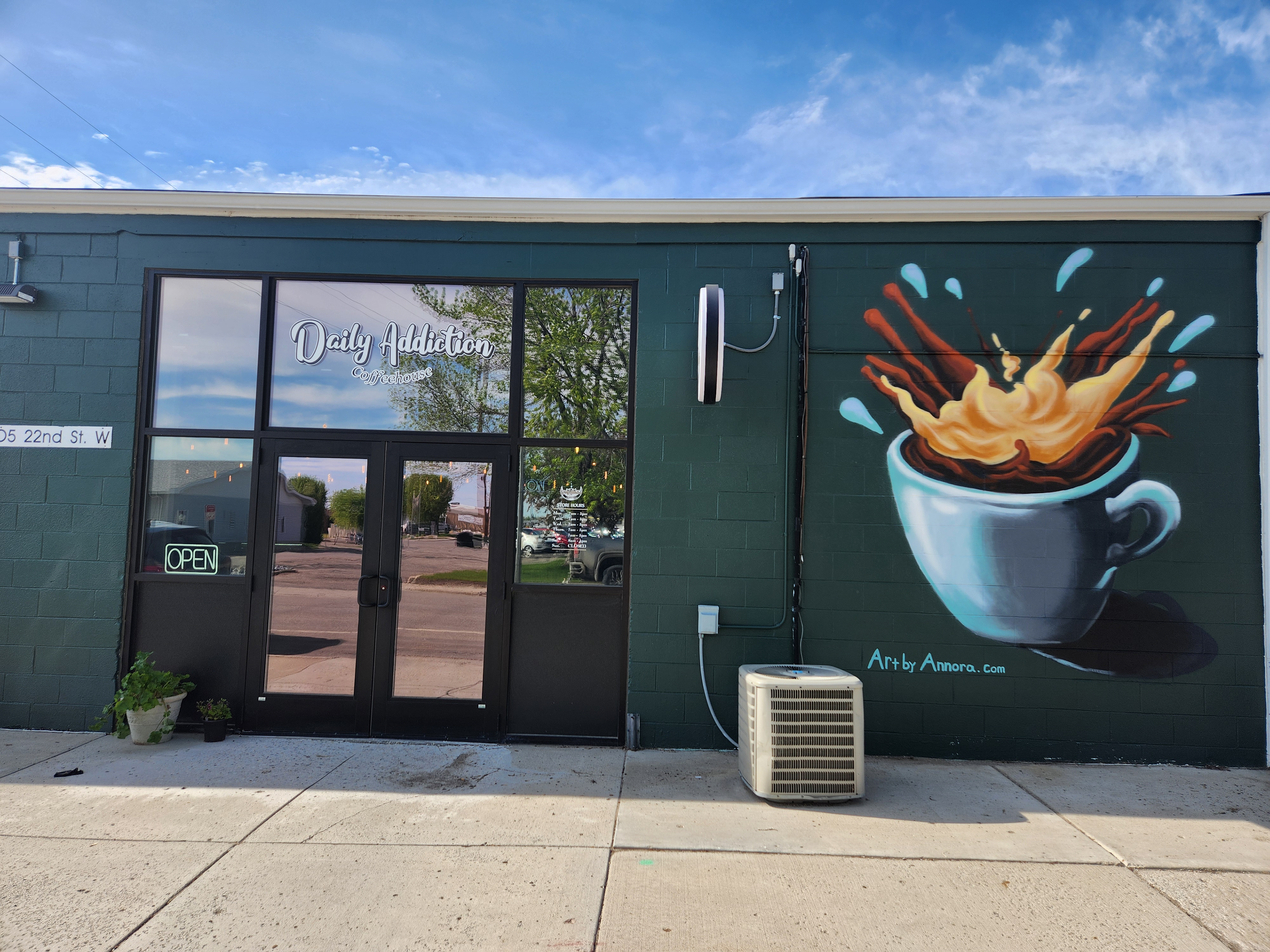 Huge coffee cup mural on the Daily Addiction Coffee House.