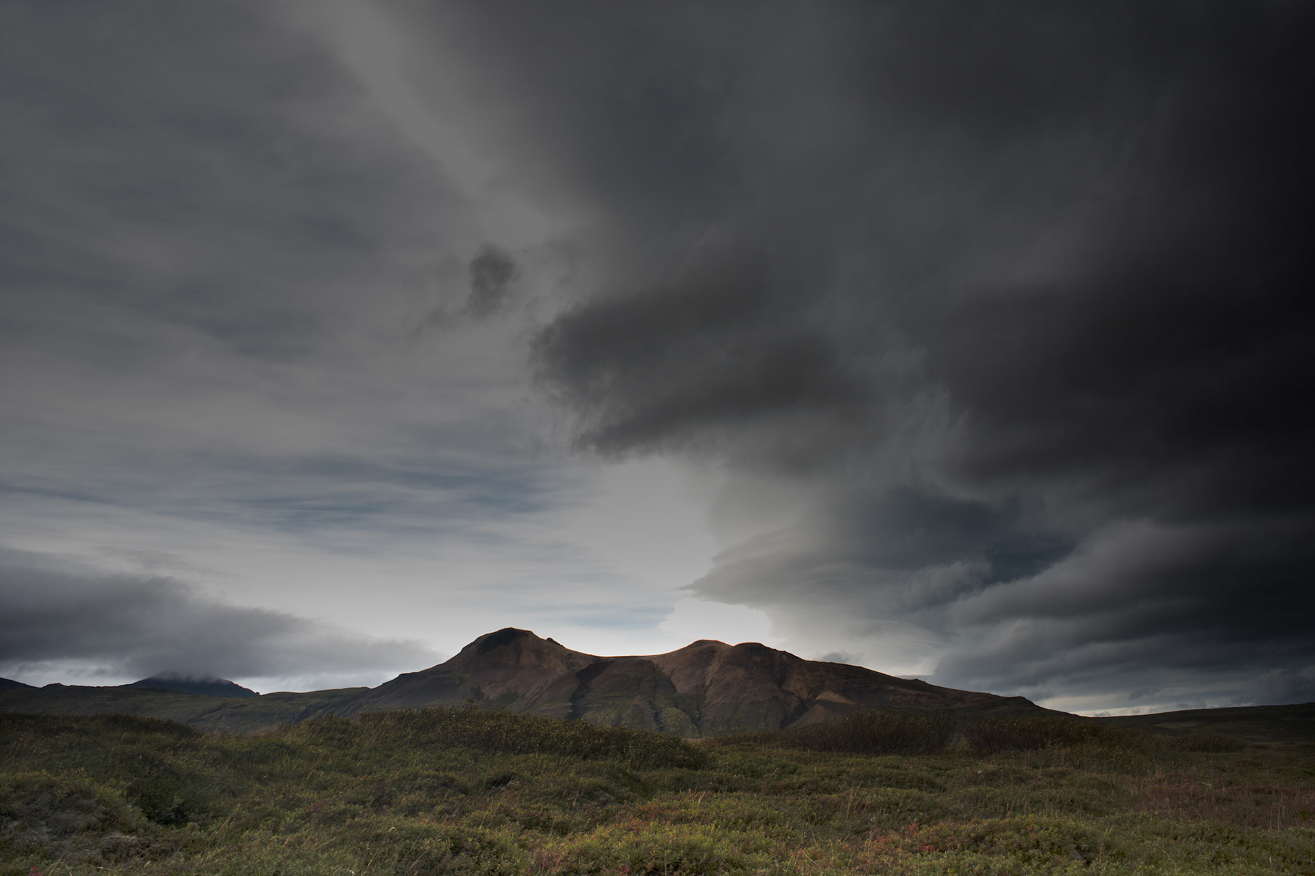 ©SVANA Stormy clouds gathering over Drápuhlíðarfjall. Usually this liparit mountain is light in colour, but turning darker under the stormy sky.