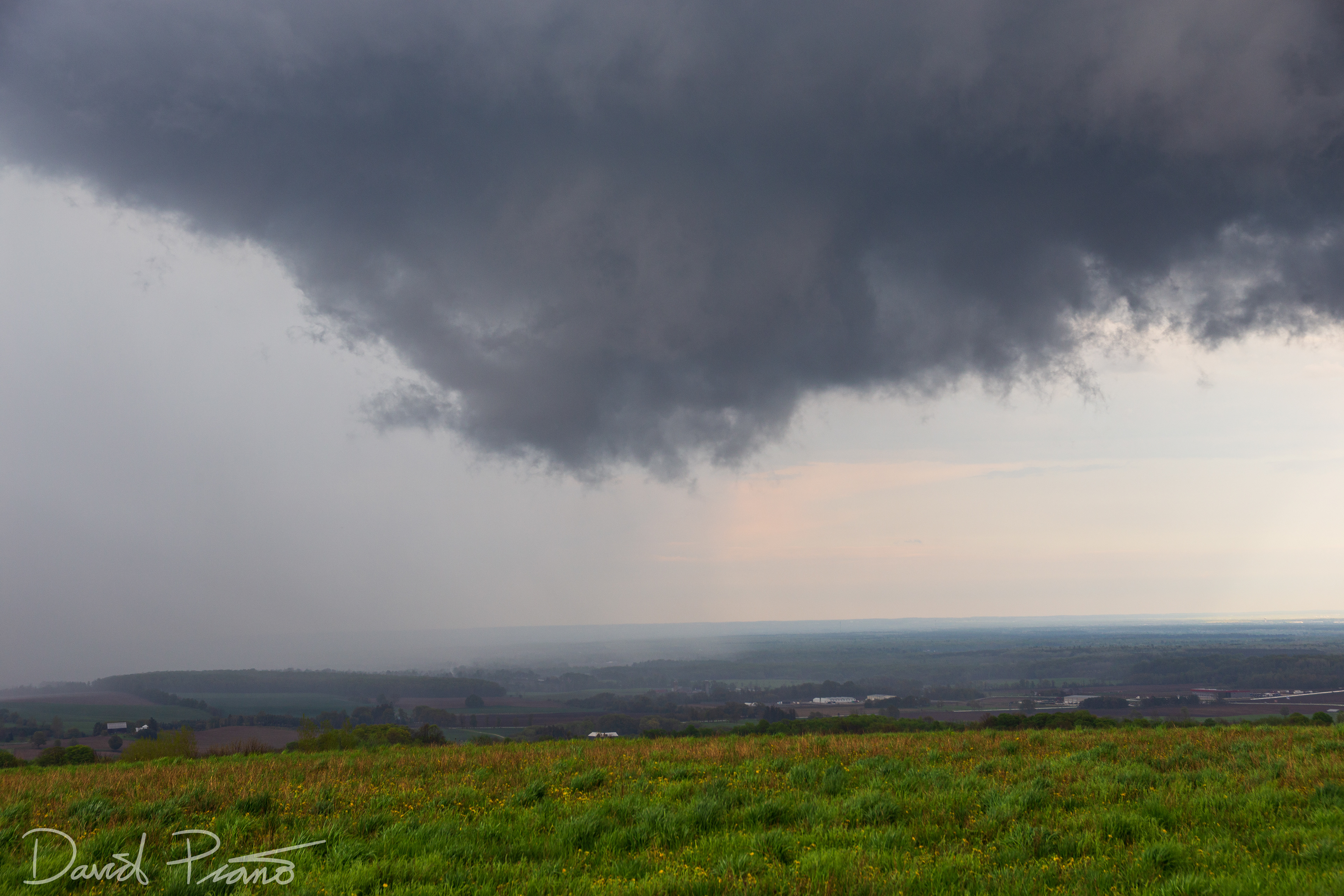 A wall cloud associated with a supercell is seen over Simcoe County from near Creemore - May 24
