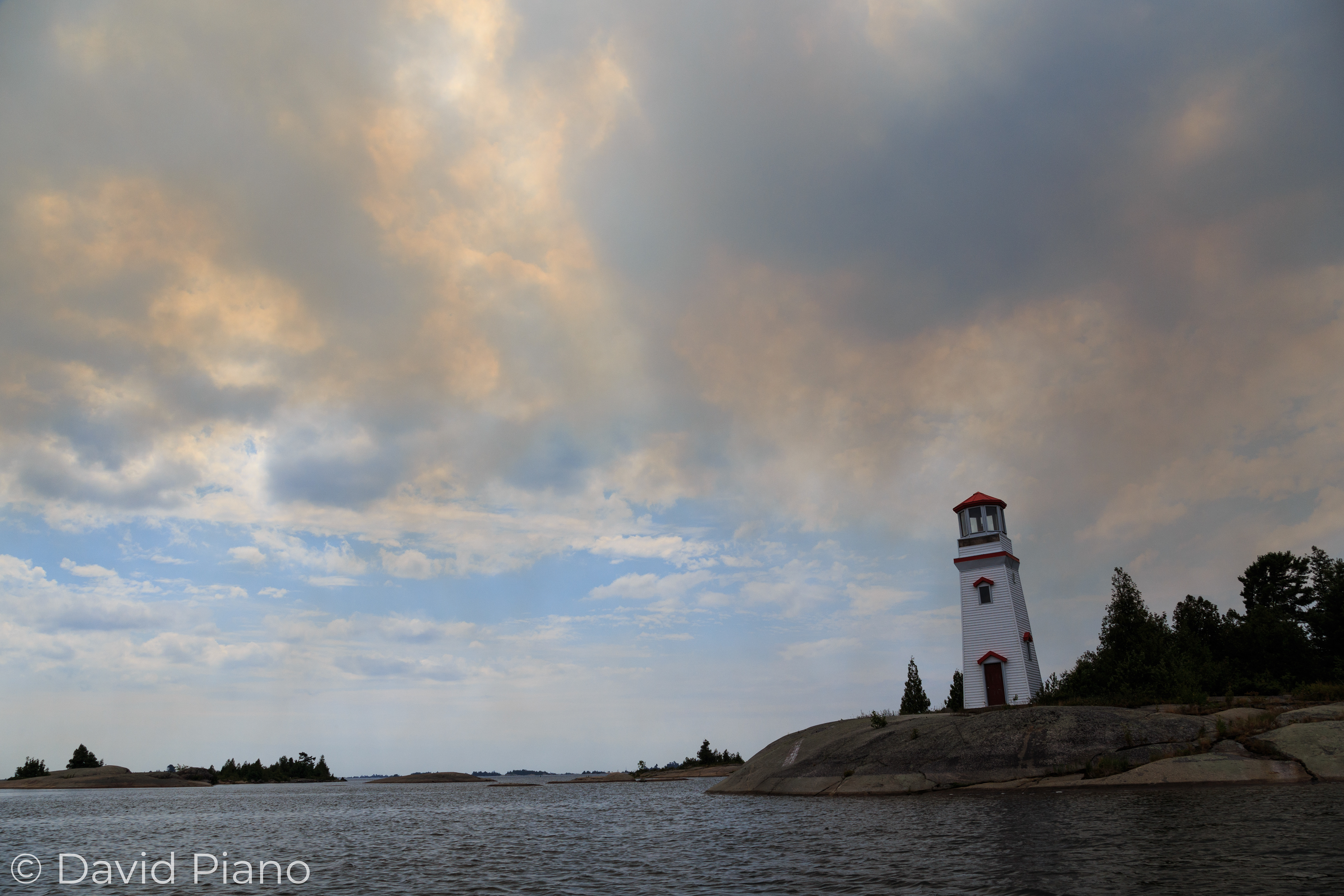 Smoke drifts over the Key Harbour Lighthouse - Parry Sound 33 Forest Fire - 07/21/2018