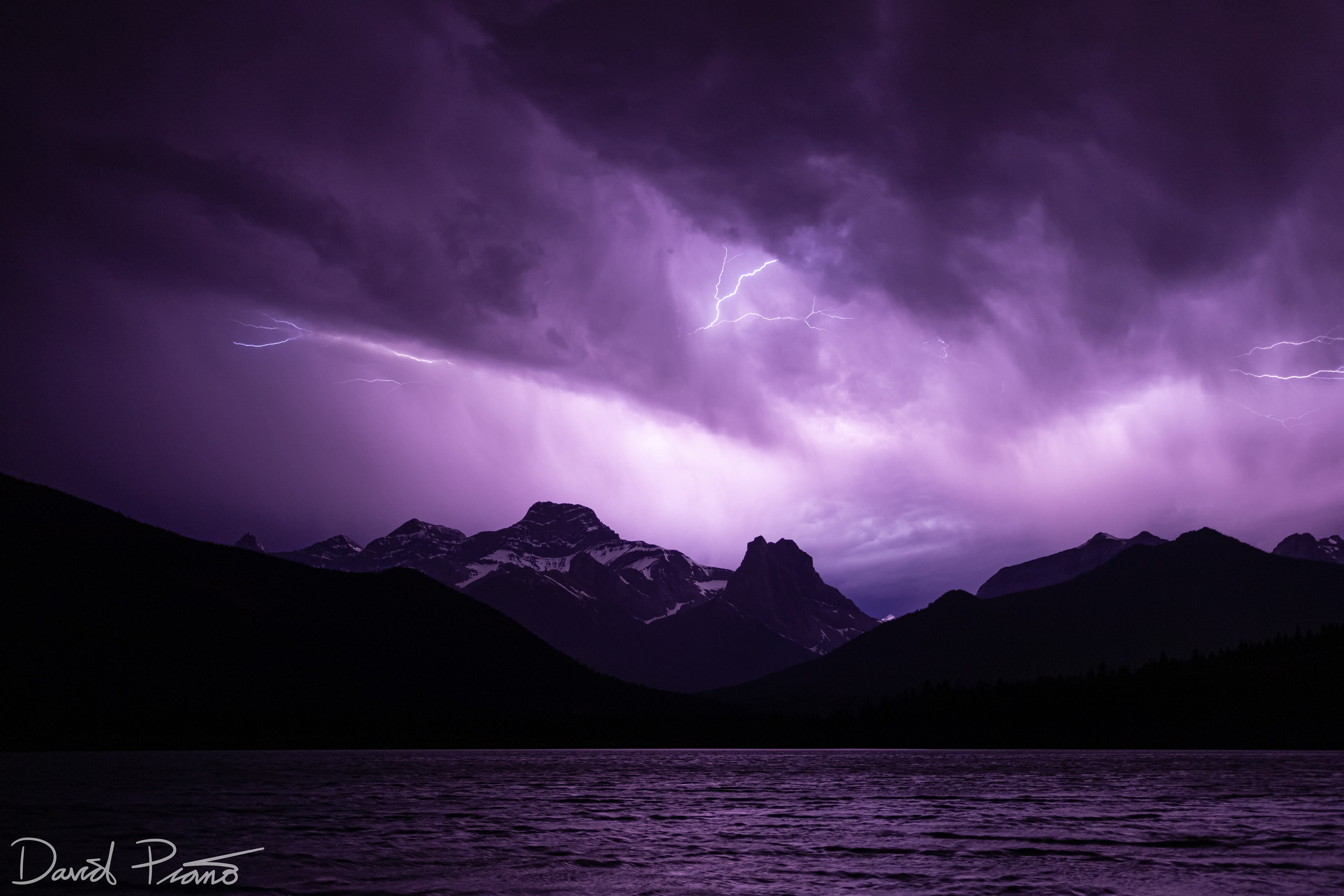 Electrifying lightning display over the Rockies seen from Gap Lake in Canmore, AB - June 2021